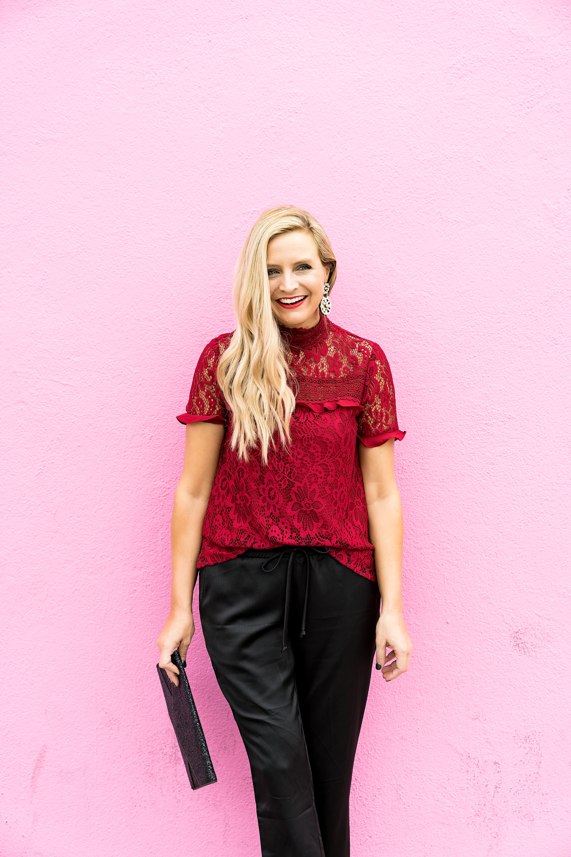 Gibson x Glam Collection Outfits featured by top Houston fashion blog, Fancy Ashley: a blonde woman walking wearing red lace top, silk joggers, leopard heels and black clutch