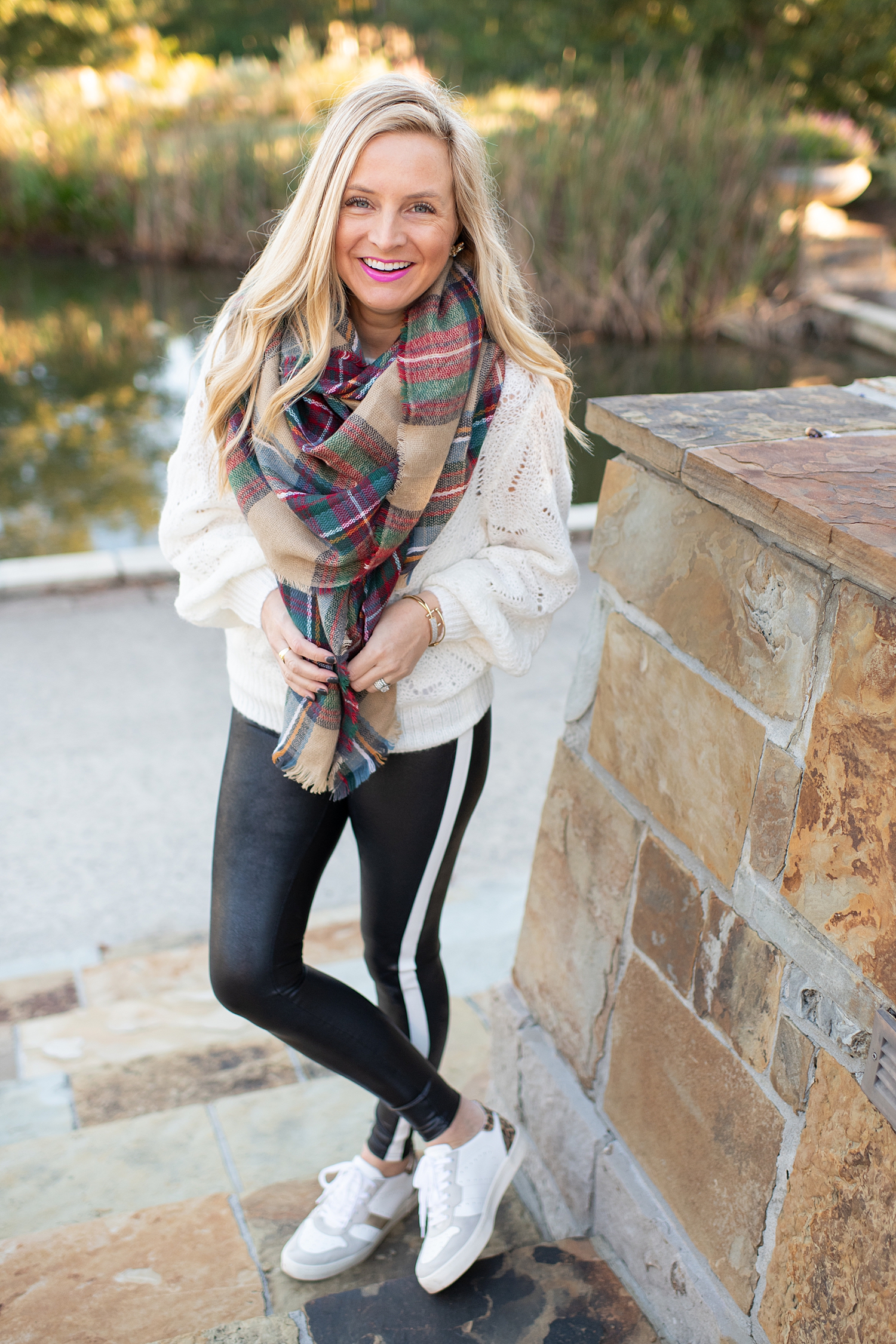 The Ultimate Cyber Monday Shopping Deals featured by top Houston life and style blogger, Fancy Ashley: picture of a woman wearing SPANX faux leather leggings, plaid scarf, metallic leopard sneakers, tote bag, Halogen sweater