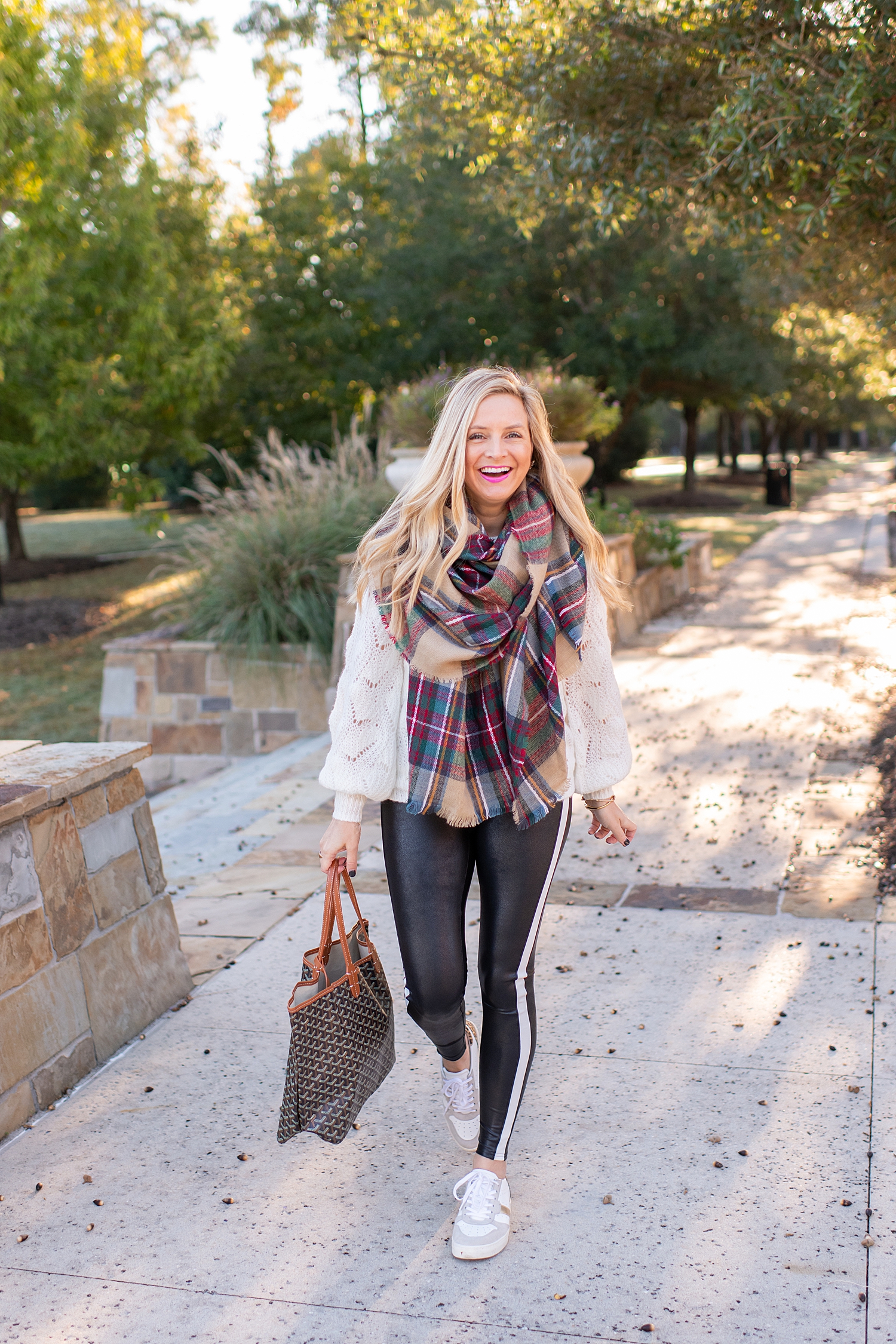 The Ultimate Cyber Monday Shopping Deals featured by top Houston life and style blogger, Fancy Ashley: picture of a woman wearing SPANX faux leather leggings, plaid scarf, metallic leopard sneakers, tote bag, Halogen sweater