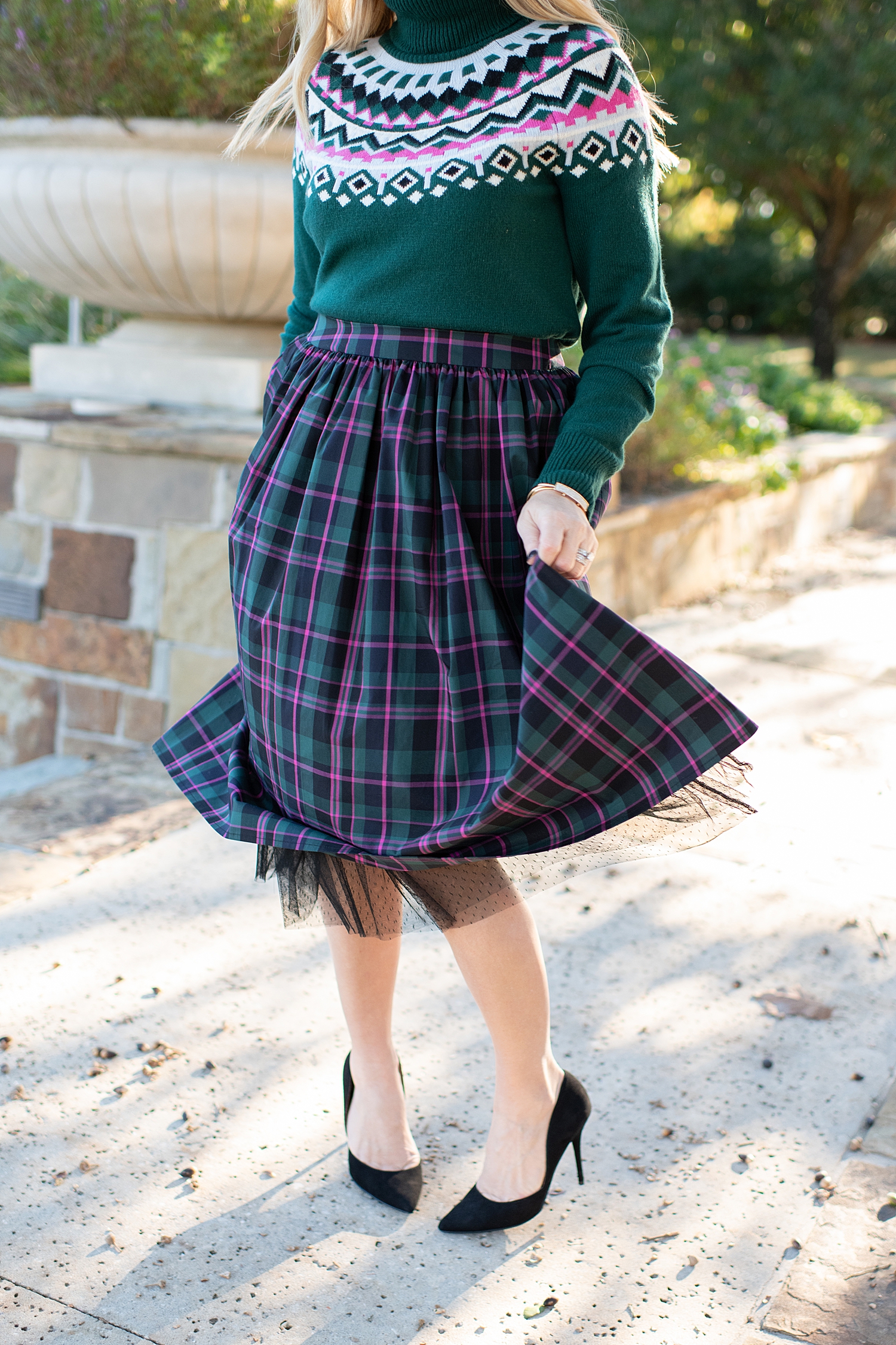 Top Houston fashion blogger, Fancy Ashley, features 7 Holiday Outfits perfect for the season: image of a woman wearing a Plaid skirt, green turtleneck sweater and Sam Edelman heels, all available at Nordstrom