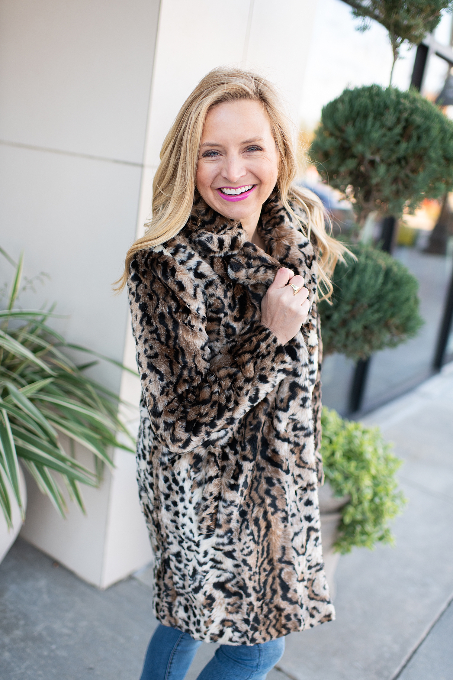 Fancy Ashley x Social Threads collection featured by top Houston fashion blogger, Fancy Ashley: image of a woman wearing a Social Threads leopard faux fur coat, Social Threads skinny jeans, and Golden Goose sneakers