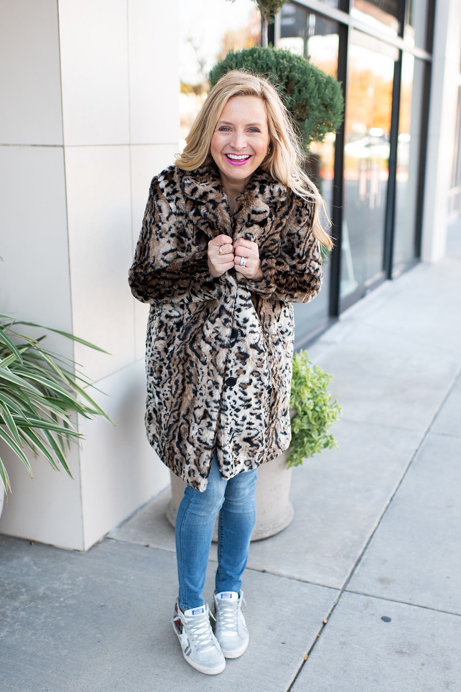Fancy Ashley x Social Threads collection featured by top Houston fashion blogger, Fancy Ashley: image of a woman wearing a Social Threads leopard faux fur coat, Social Threads skinny jeans, and Golden Goose sneakers