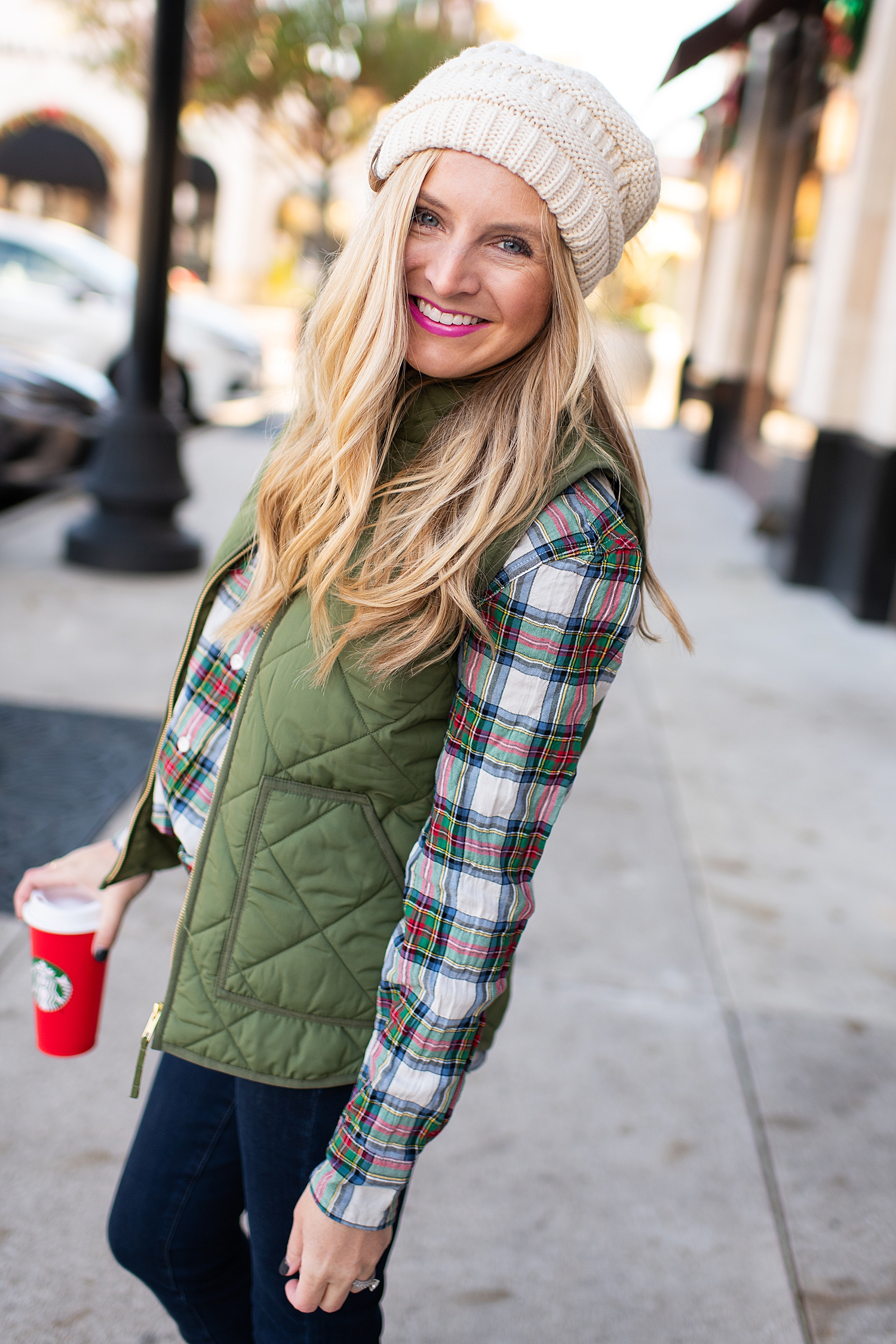 Winter fashion Amazon Favorites featured by top Houston fashion blogger, Fancy Ashley: image of a woman wearing a J.Crew tartan shirt, J.Crew puffer vest, Nordstrom high waist ankle jeans, pom pom beanie and Sole Society bootie