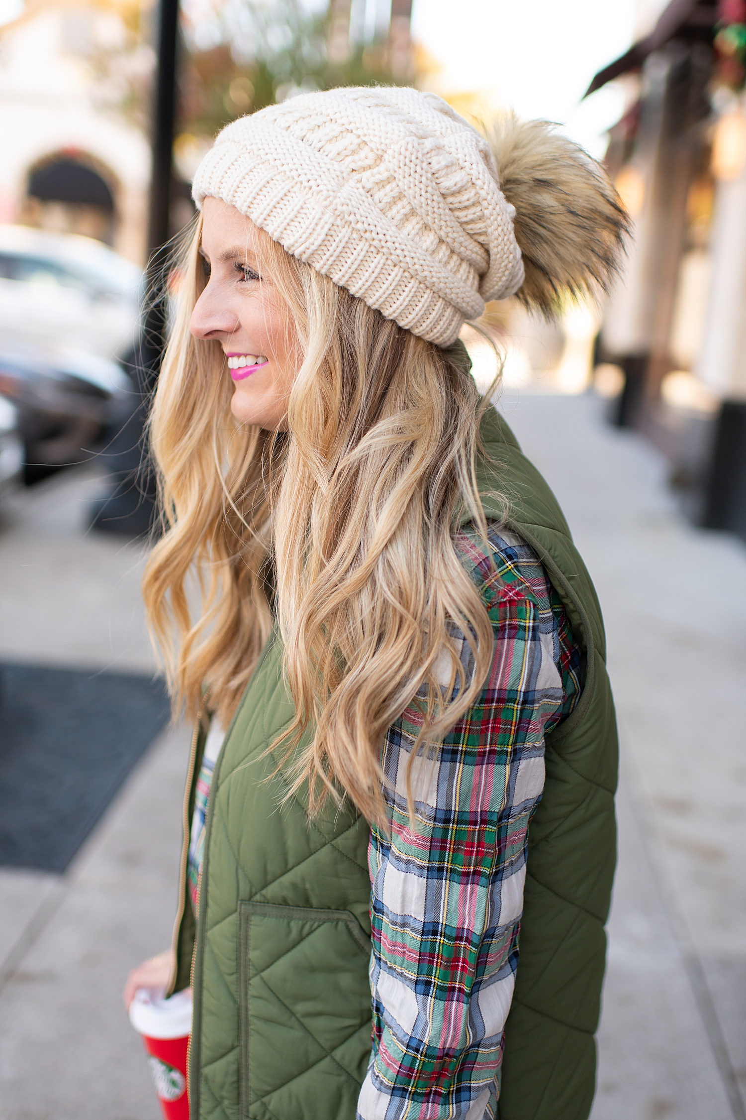 Winter fashion Amazon Favorites featured by top Houston fashion blogger, Fancy Ashley: image of a woman wearing a J.Crew tartan shirt, J.Crew puffer vest, Nordstrom high waist ankle jeans, pom pom beanie and Sole Society bootie