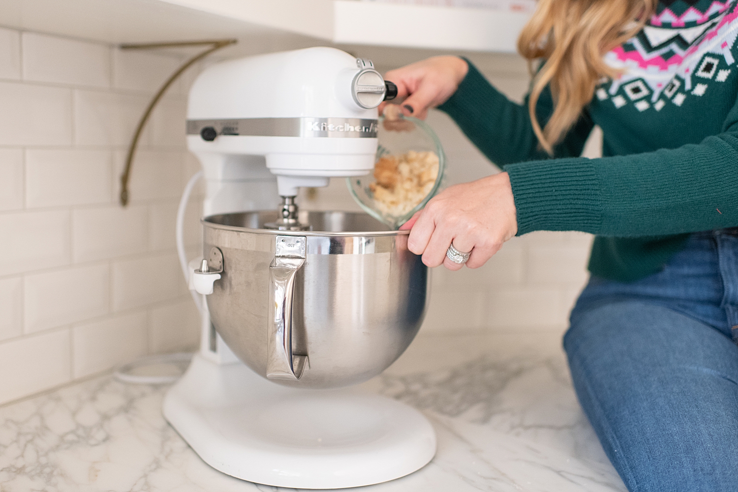 Gluten Free Sugar Cookie Truffles featured by top Houston lifestyle blog, Fancy Ashley: blonde woman sat on countertop pouring ingredients for her sugar cookie truffles