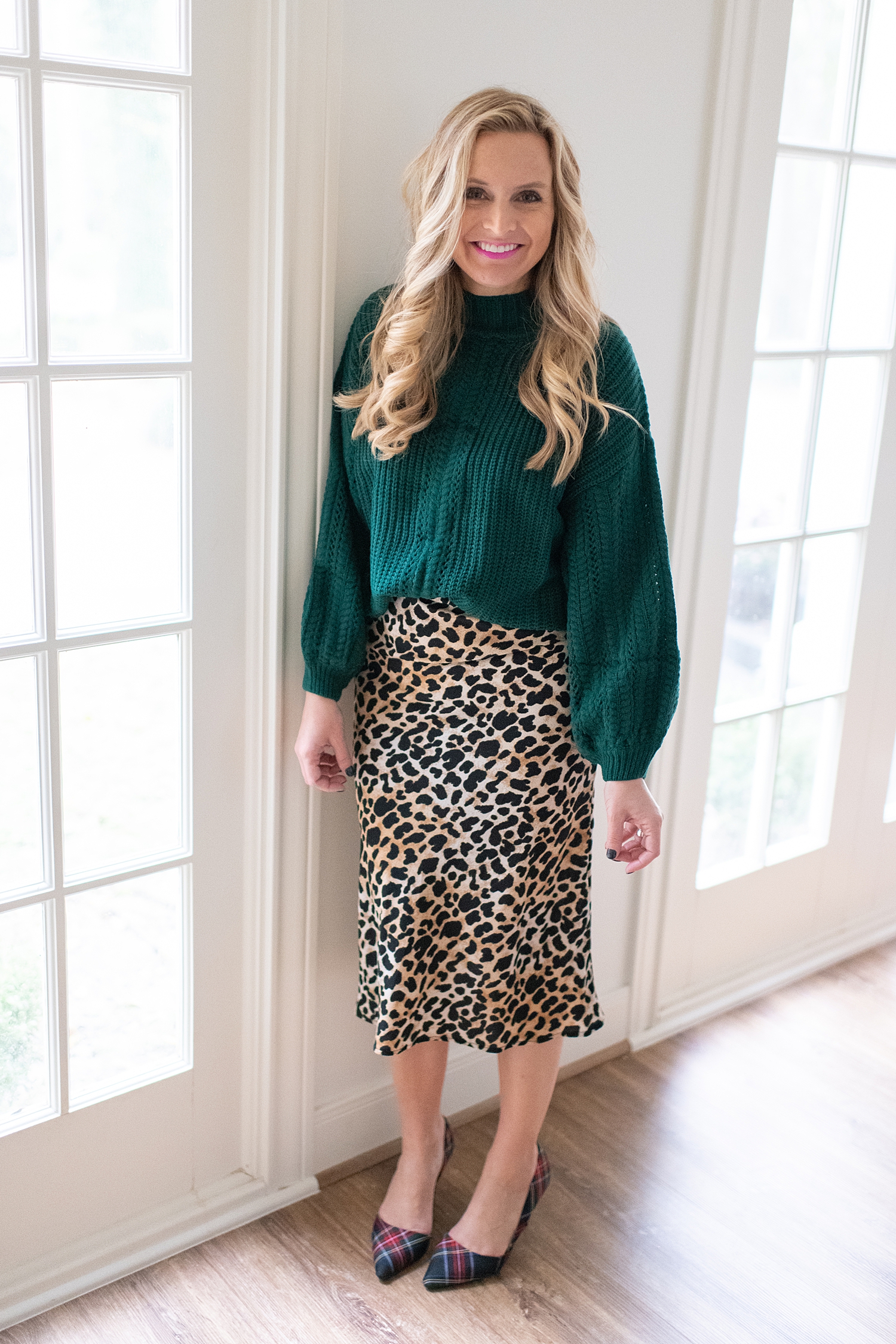Fancy Ashley x Social Threads collection featured by top Houston fashion blogger, Fancy Ashley: image of a woman wearing a Social Threads Leopard skirt and green sweater