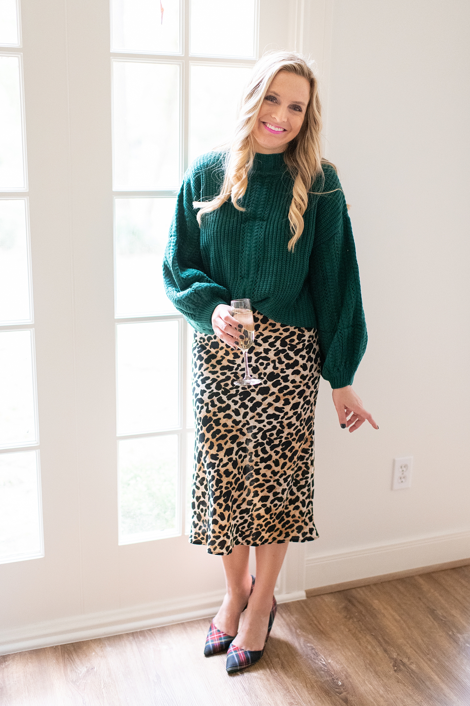The Ultimate Cyber Monday Shopping Deals featured by top Houston life and style blogger, Fancy Ashley: picture of a woman wearing a Social Threads green cozy sweater, leopard skirt and plaid heels