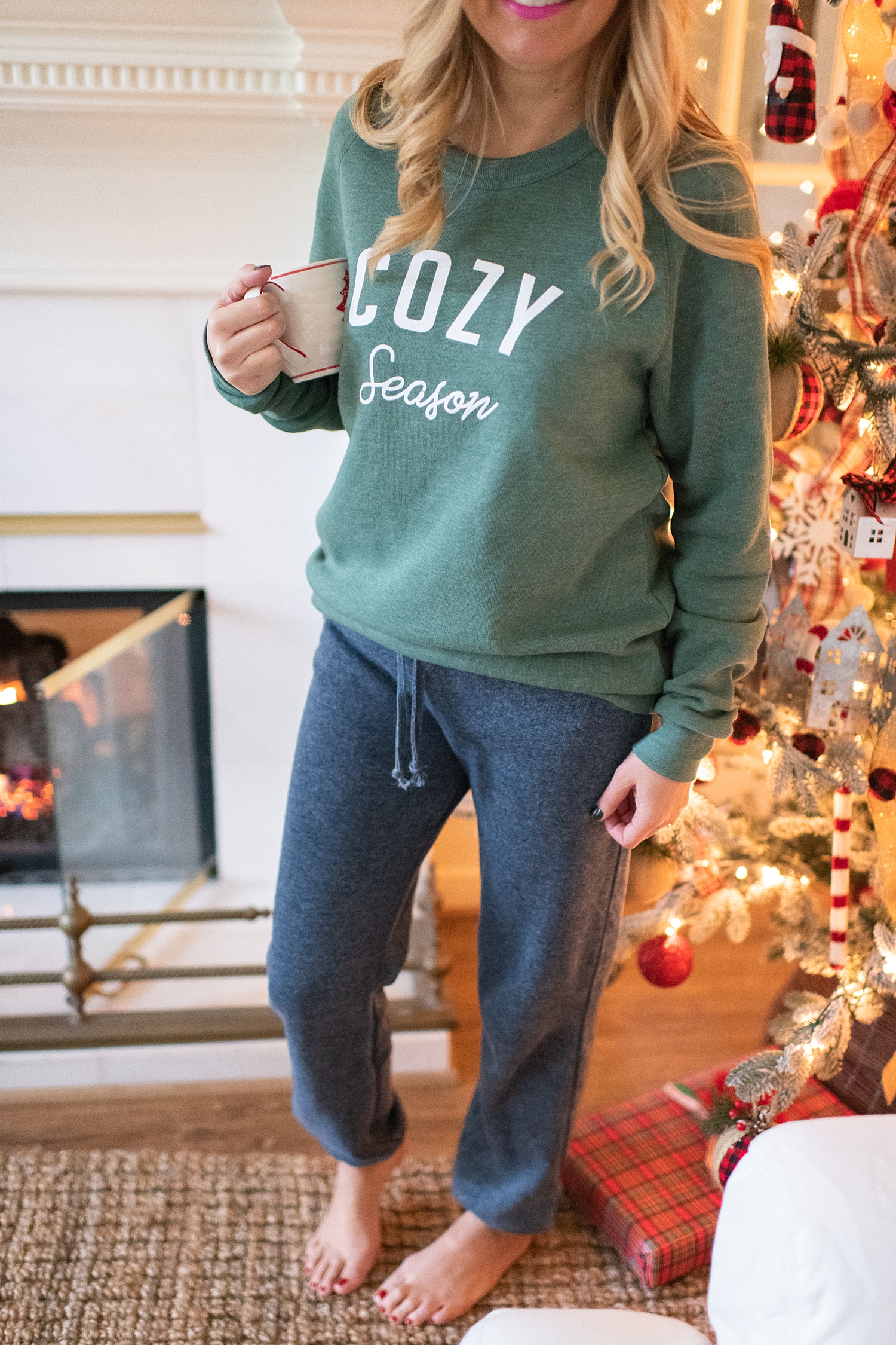 The Ultimate Cyber Monday Shopping Deals featured by top Houston life and style blogger, Fancy Ashley: picture of a woman wearing a Social Threads green cozy sweater and grey sweat pants