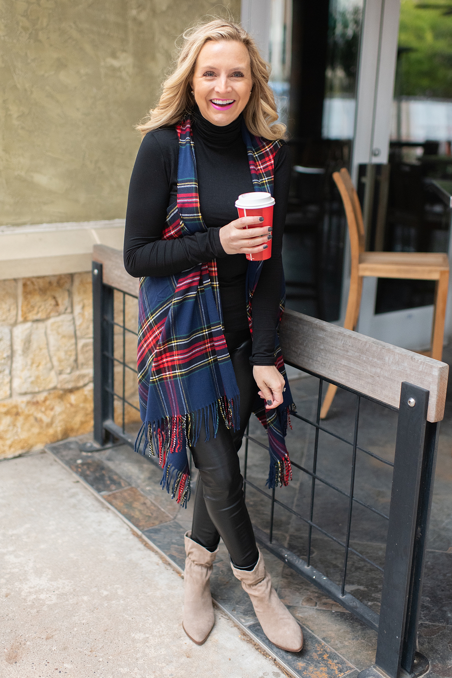 The Ultimate Cyber Monday Shopping Deals featured by top Houston life and style blogger, Fancy Ashley: picture of a woman wearing a Social Threads plaid vest, faux leather leggings, black sweater and suede booties