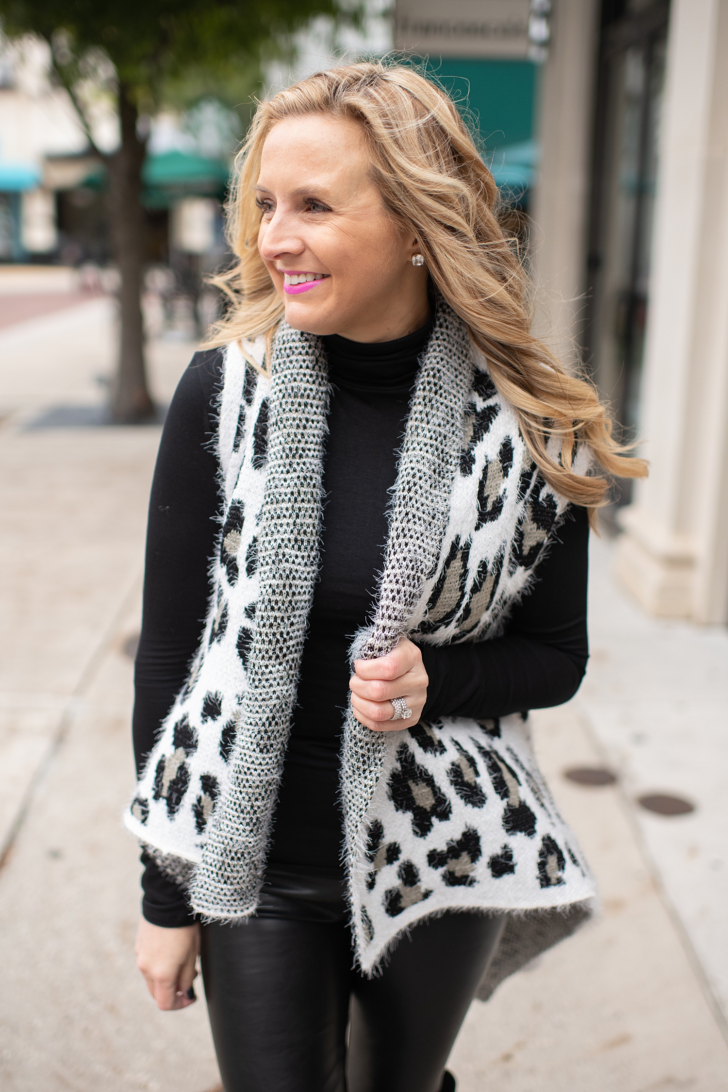 Fancy Ashley x Social Threads collection featured by top Houston fashion blogger, Fancy Ashley: image of a woman wearing a Social Threads Leopard vest, Social Threads faux leather leggings, Social Threads plaid clutch and Vince Camuto Over the Knees Boots