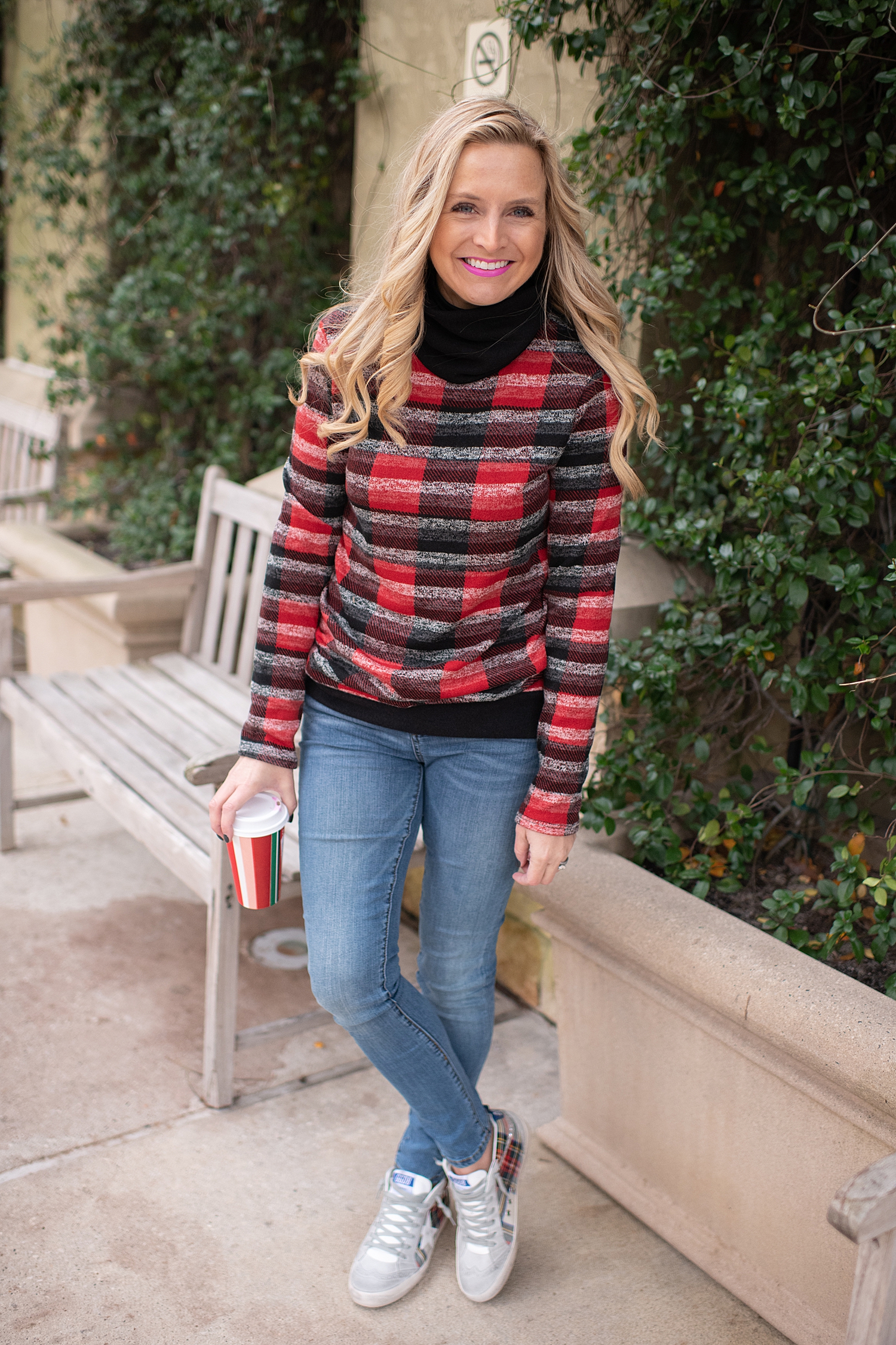 Fancy Ashley x Social Threads collection featured by top Houston fashion blogger, Fancy Ashley: image of a woman wearing a Social Threads plaid turtleneck, Social Threads skinny jeans and Golden Goose sneakers