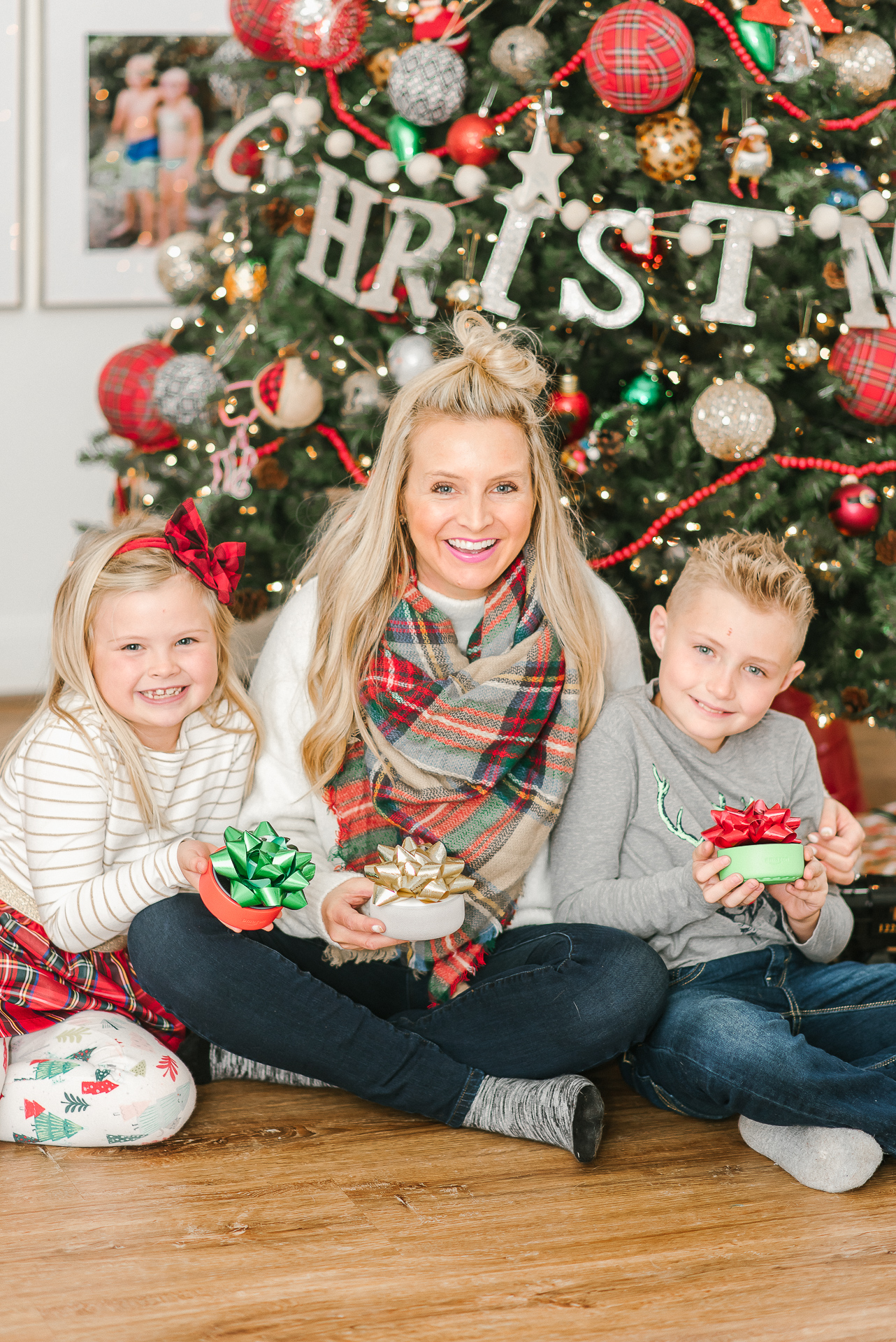 Echo Dot Kids Edition review featured by top Houston lifestyle blogger, Fancy Ashley: image of a mom and siblings holding wrapped Amazon Echos Kids Edition