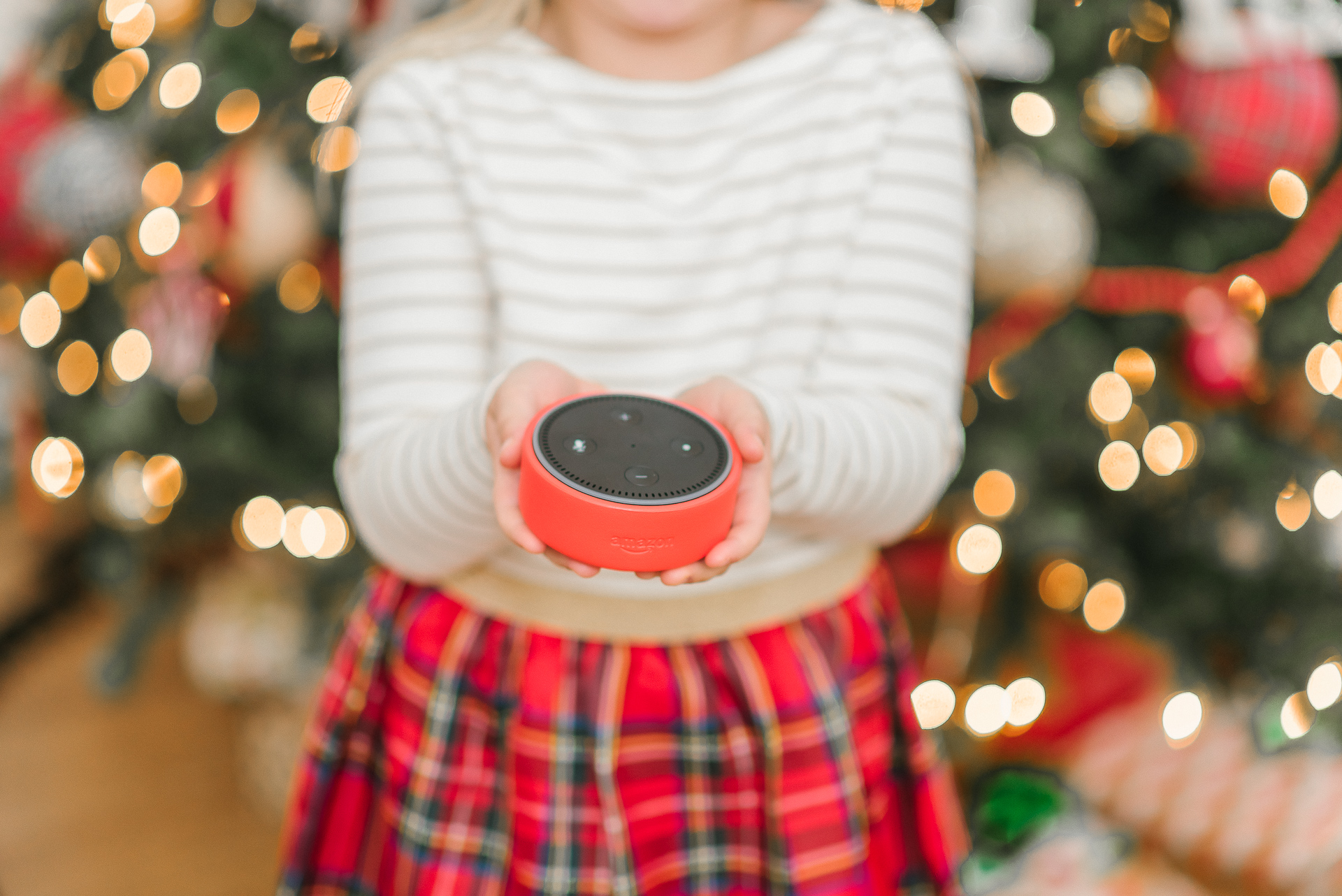 Echo Dot Kids Edition review featured by top Houston lifestyle blogger, Fancy Ashley: image of a girl holding a red Amazon Echo Kids Edition