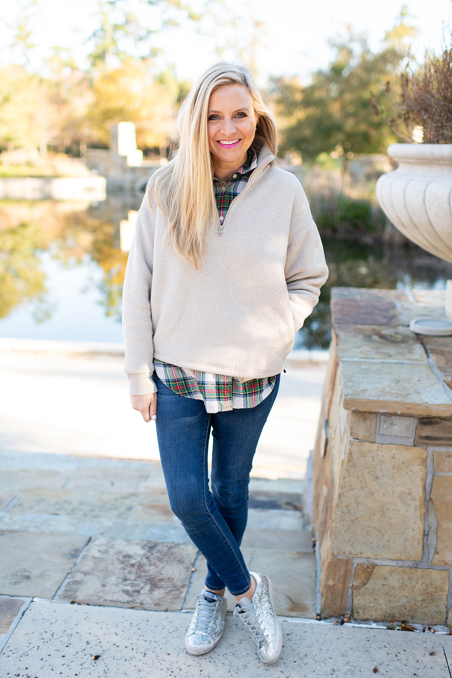 The Best Cozy Gift Ideas featured by top Houston fashion blogger, Fancy Ashley: picture of a blonde woman wearing an Everlane zip fleece, J.Crew tartan shirt, J.Crew skinny jeans and Golden Goose sneakers