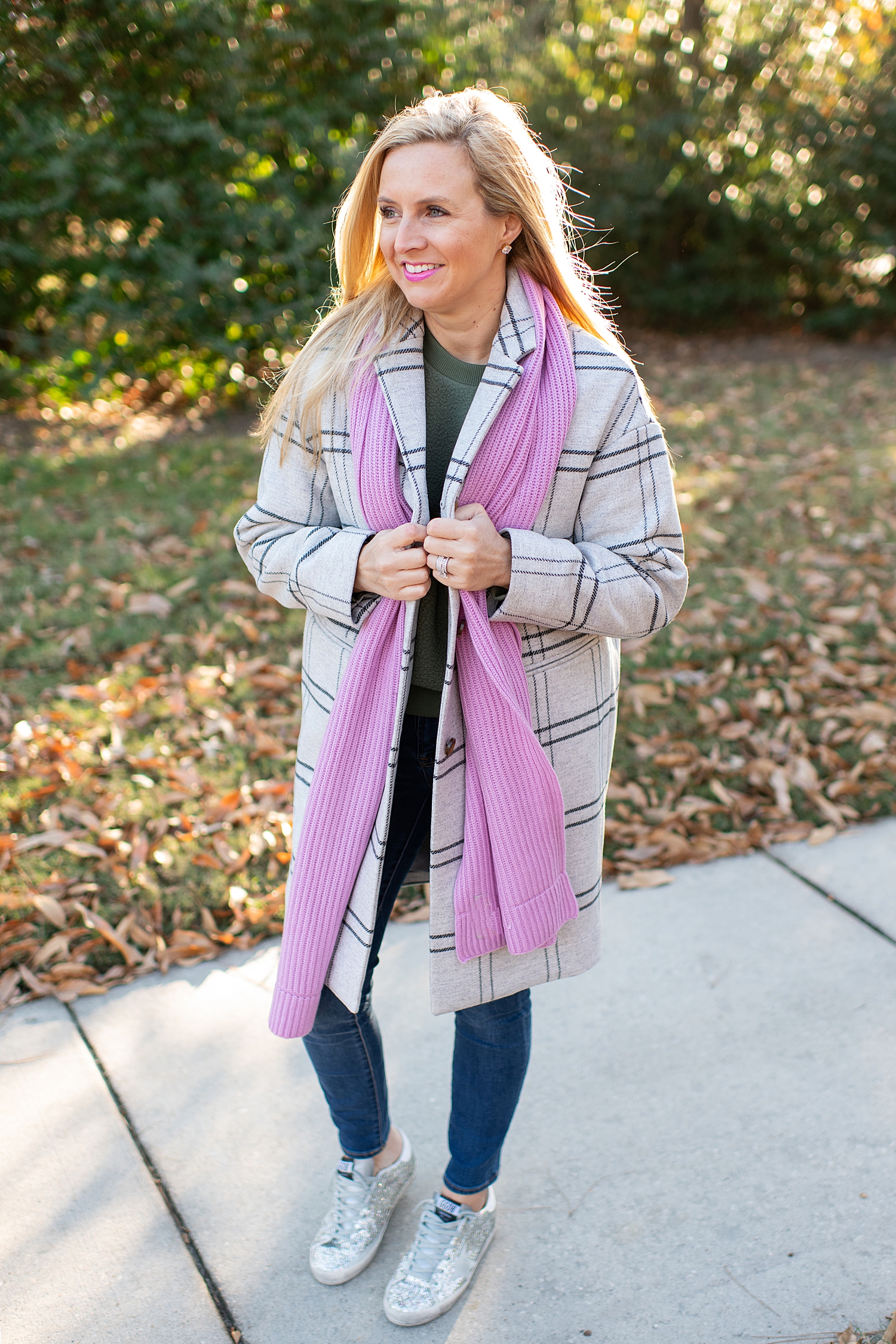 The Best Cozy Gift Ideas featured by top Houston fashion blogger, Fancy Ashley: picture of a blonde woman wearing an Everlane green cocoon coat, an Everlane cashmere scarf, an Everyone cashmere beanie, green Everlane fleece sweatshirt, J.Crew tartan shirt, J.Crew skinny jeans and Golden Goose sneakers