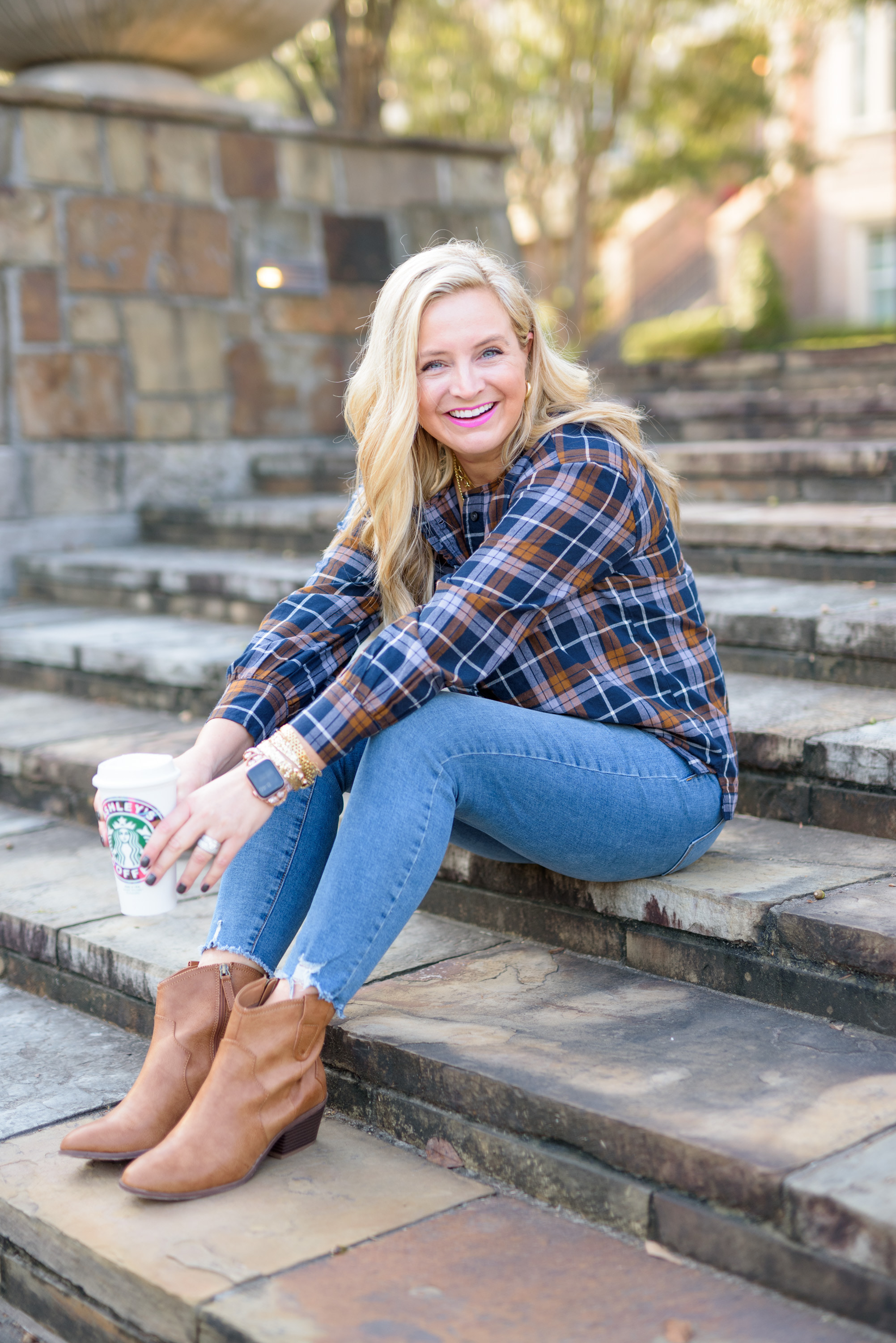 Fall Plaid by popular Houston fashion blog, Fancy Ashley: image of a woman wearing a a blue and brown plaid top, distressed hem jeans, and brown ankle boots. 