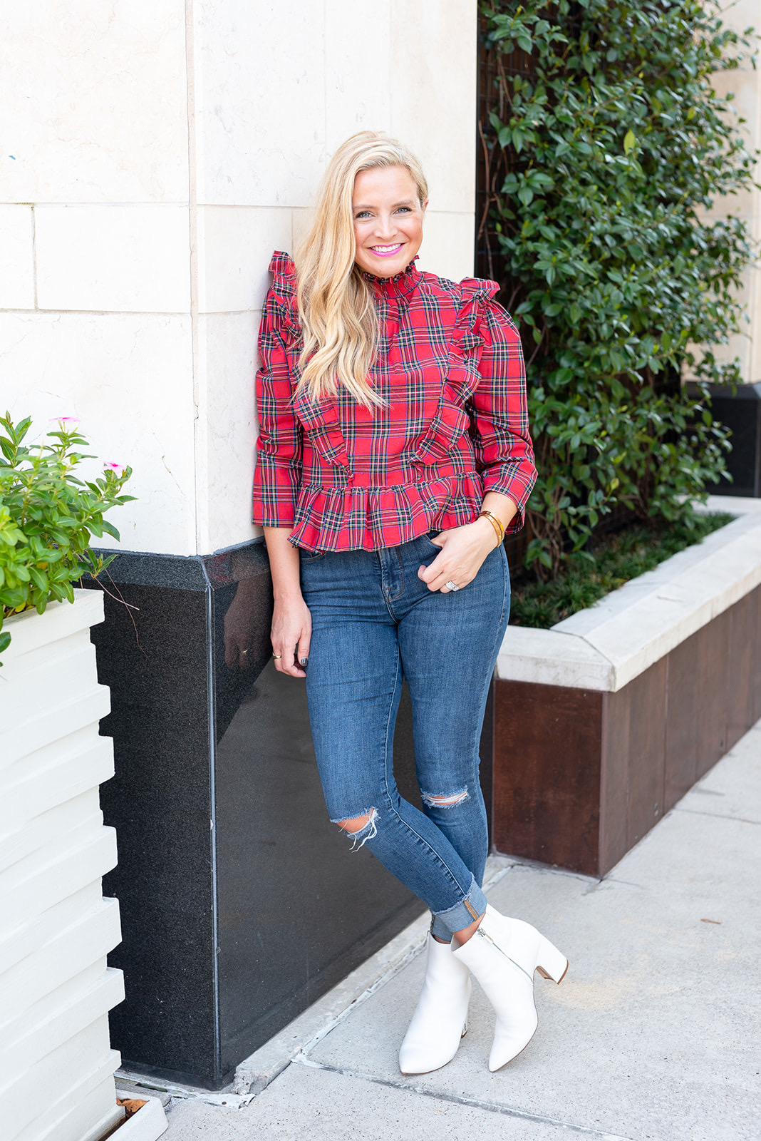Fall Plaid by popular Houston fashion blog, Fancy Ashley: image of a woman wearing a a red ruffle plaid top, jeans, and white ankle boots. 