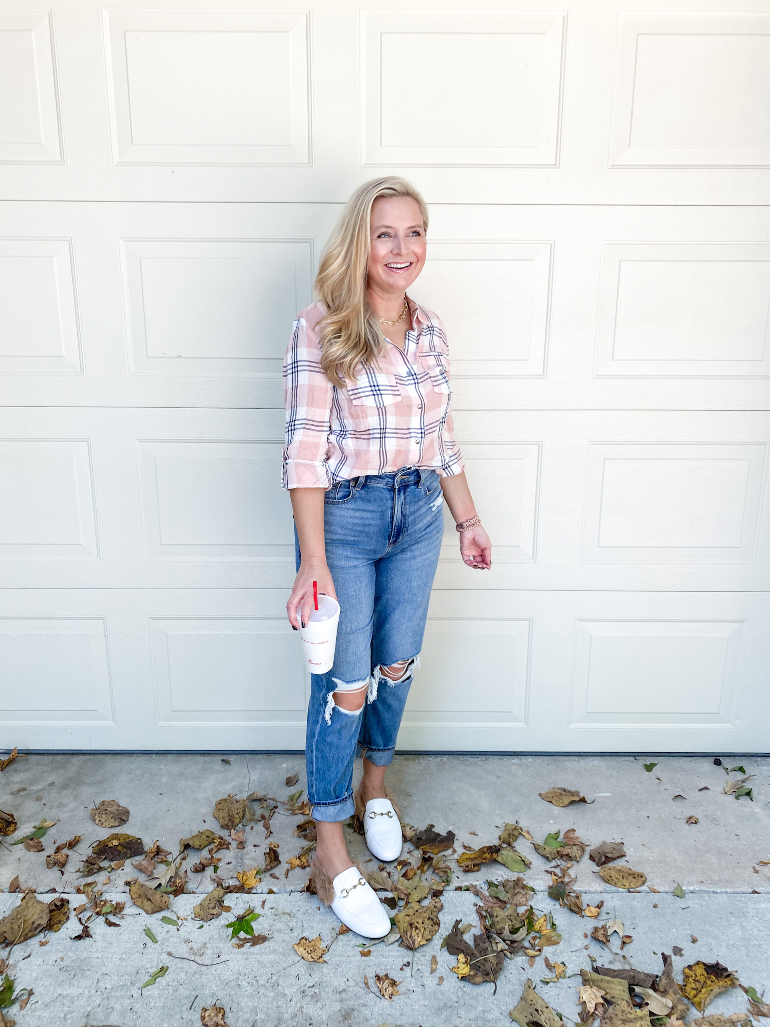 Fall Plaid by popular Houston fashion blog, Fancy Ashley: image of a woman wearing a plaid top, distressed jeans, and white faux fur lined mules. 