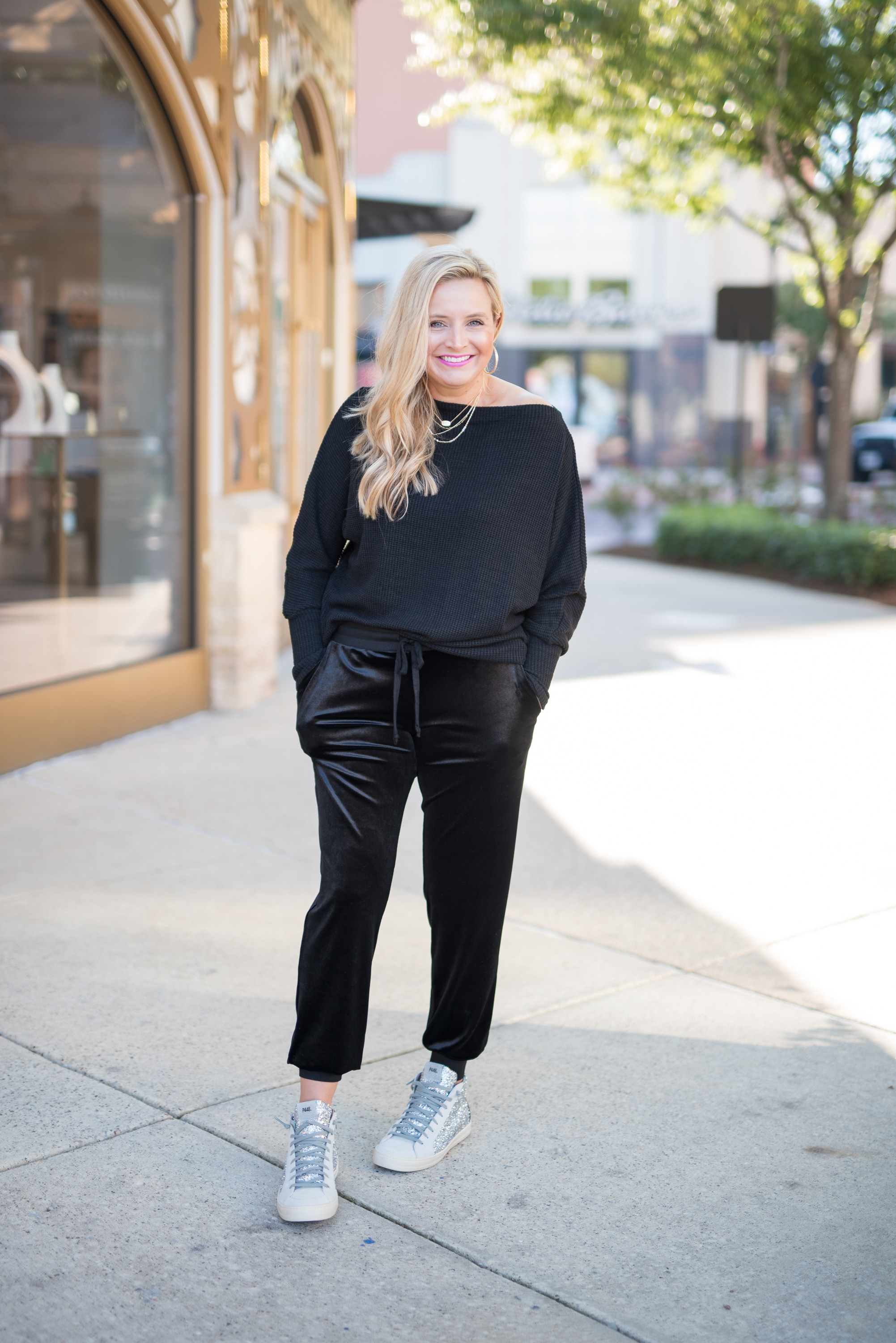 November Outfits by popular Houston fashion blog, Fancy Ashley: image of a woman wearing a black off the shoulder sweater, and black velvet joggers. 