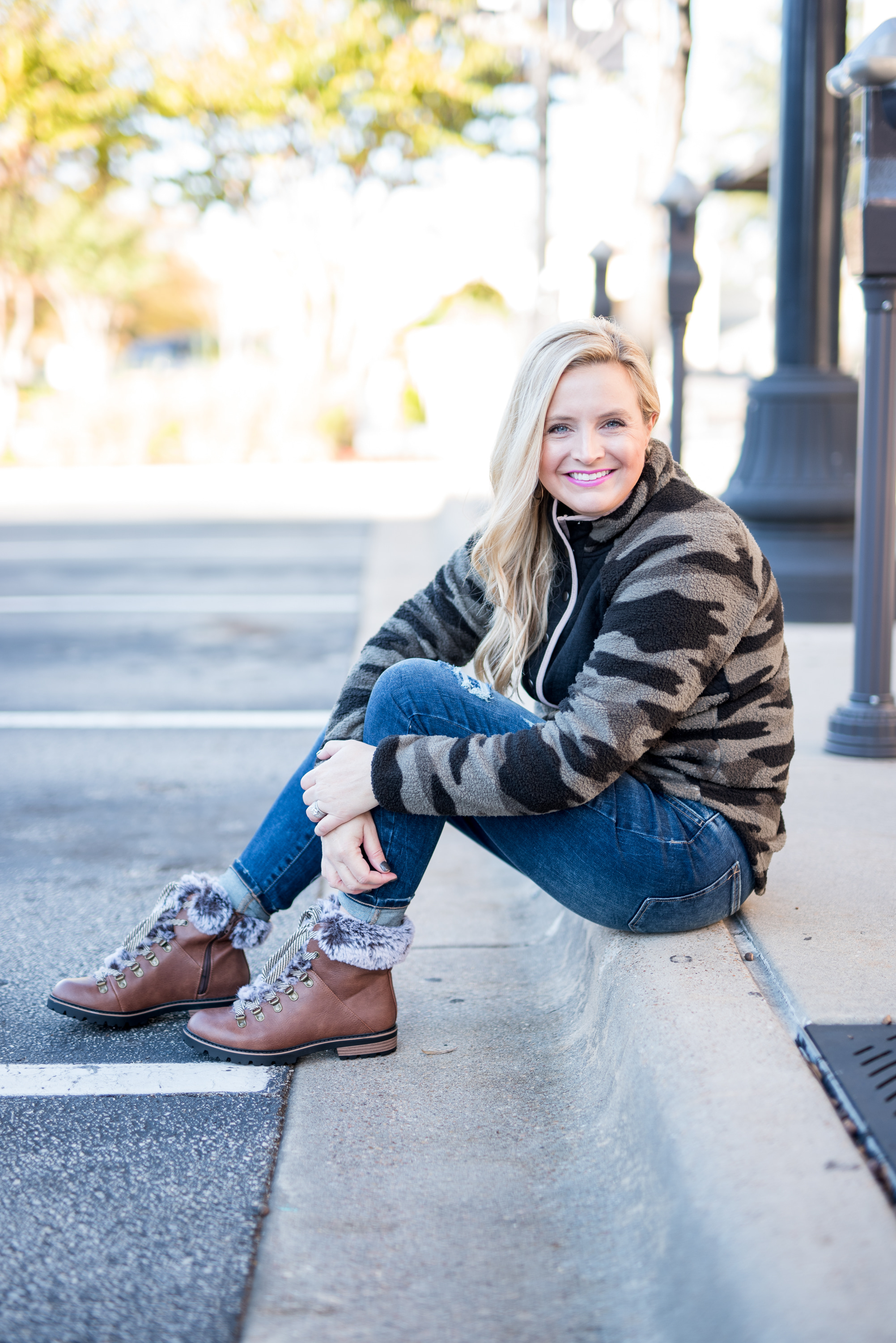 Maurice's Clothing by popular Houston fashion blog, Fancy Ashley: image of a woman wearing a Maurice's camo fleece pullover, distressed denim, and brown fur trimmed combat boots. 