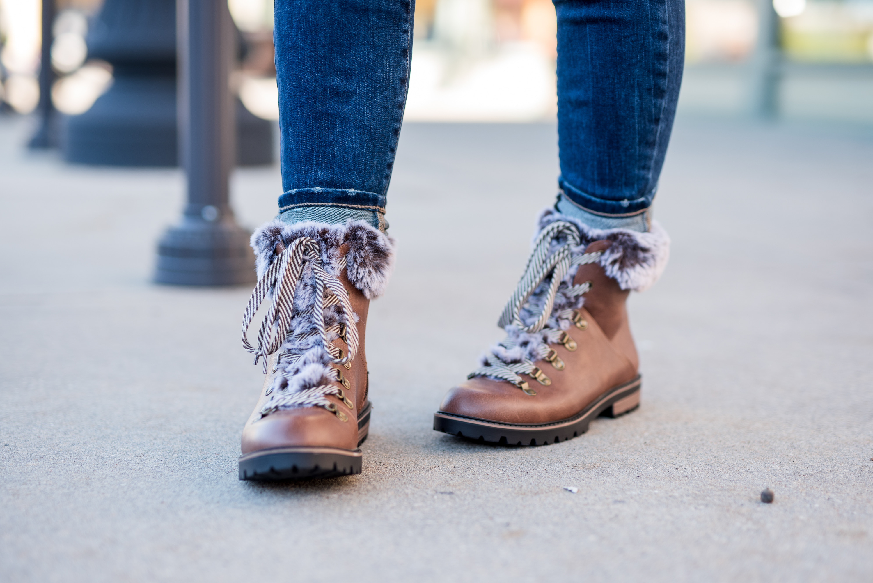 Maurice's Clothing by popular Houston fashion blog, Fancy Ashley: image of a woman wearing jeans and brown fur trimmed combat boots. 