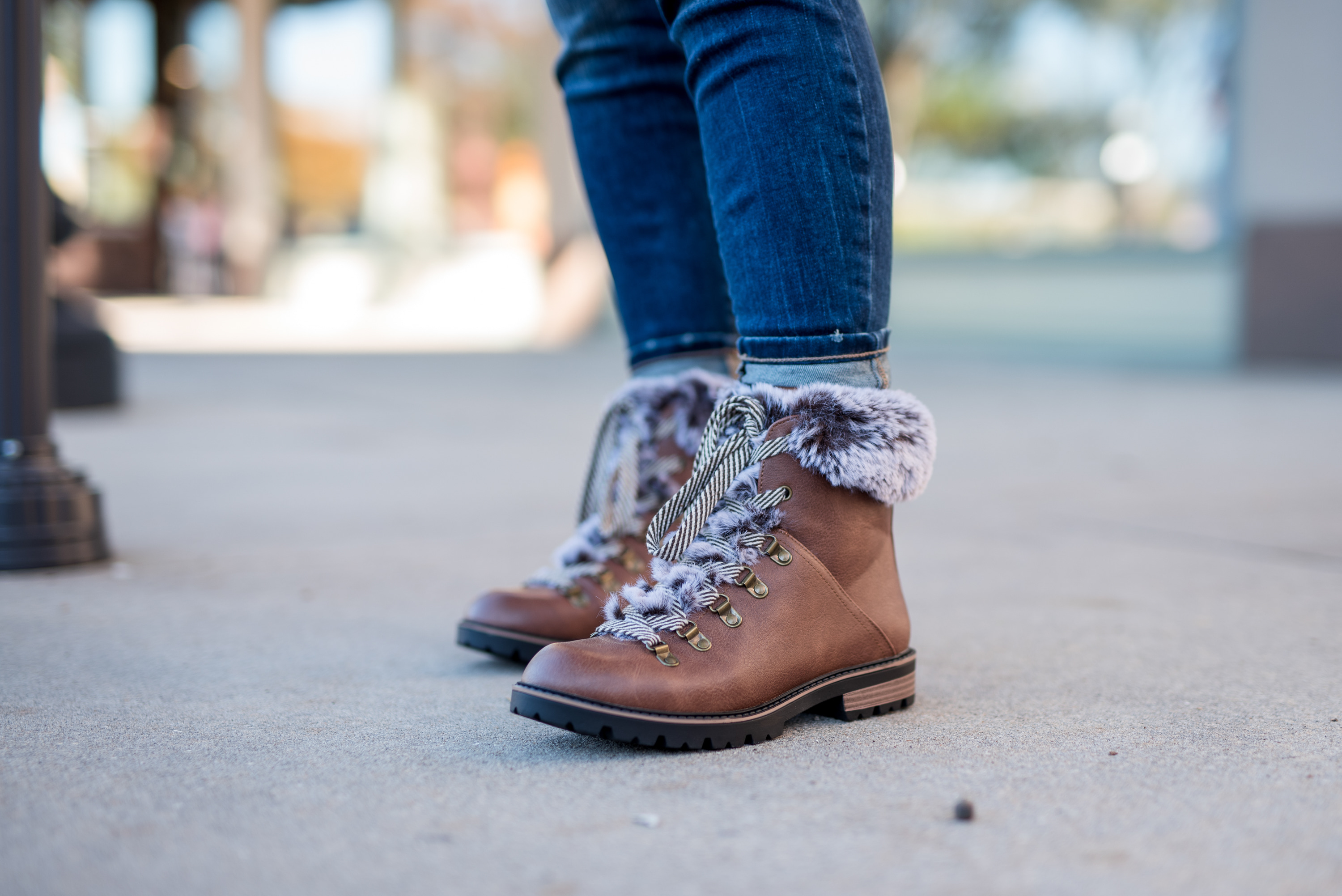 Maurice's Clothing by popular Houston fashion blog, Fancy Ashley: image of a woman wearing a Maurice's camo fleece pullover, distressed denim, and brown fur trimmed combat boots. 