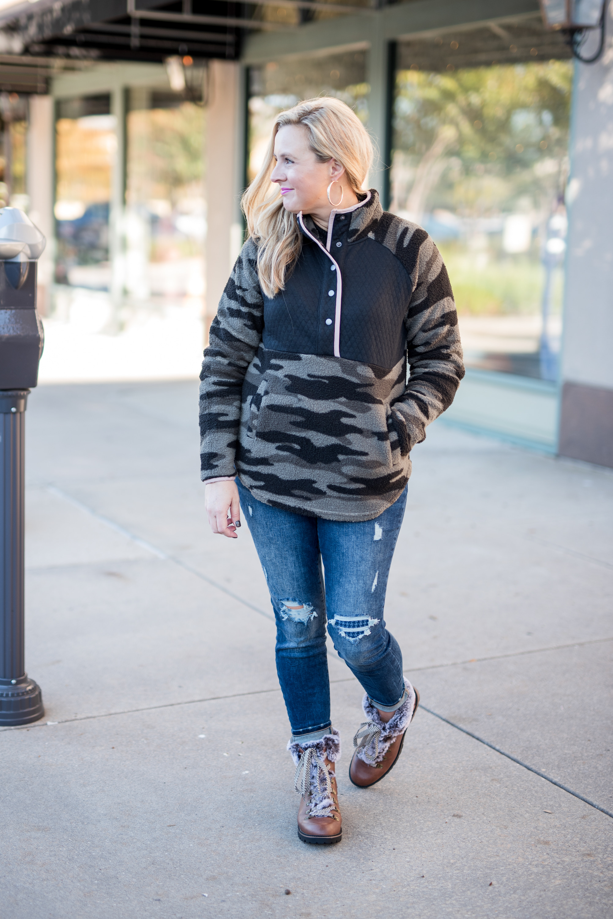 Maurice's Clothing by popular Houston fashion blog, Fancy Ashley: image of a woman wearing a Maurice's camo fleece pullover, distressed denim, and brown fur trimmed combat boots. 