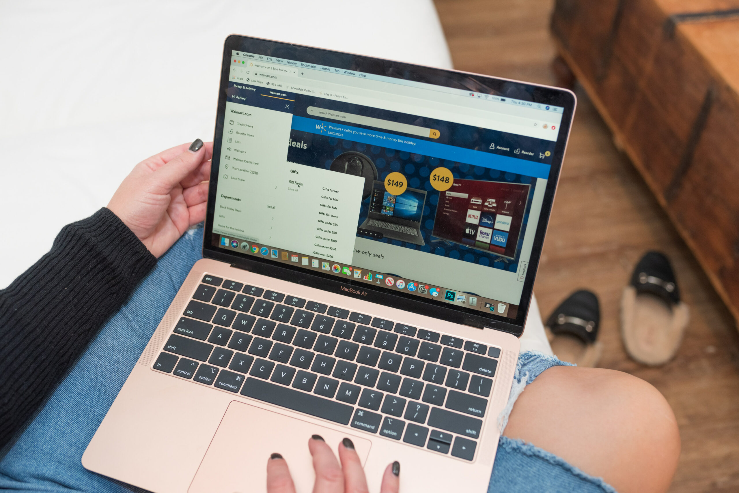 Walmart Gift Ideas by popular Houston life and style blog, Fancy Ashley: image of a woman looking at her open rose gold lap top. 