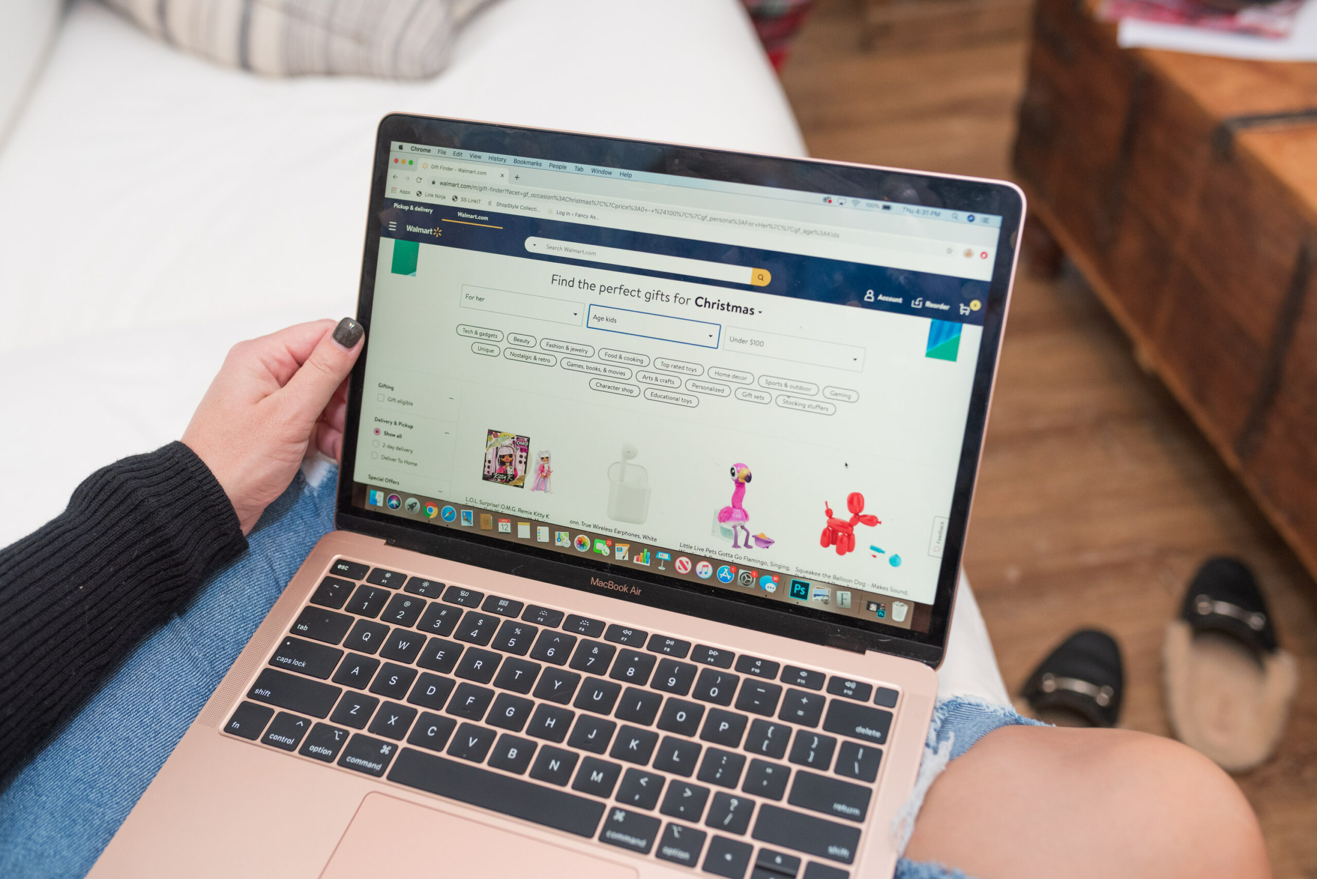 Walmart Gift Ideas by popular Houston life and style blog, Fancy Ashley: image of a woman shopping online on her rose gold laptop. 