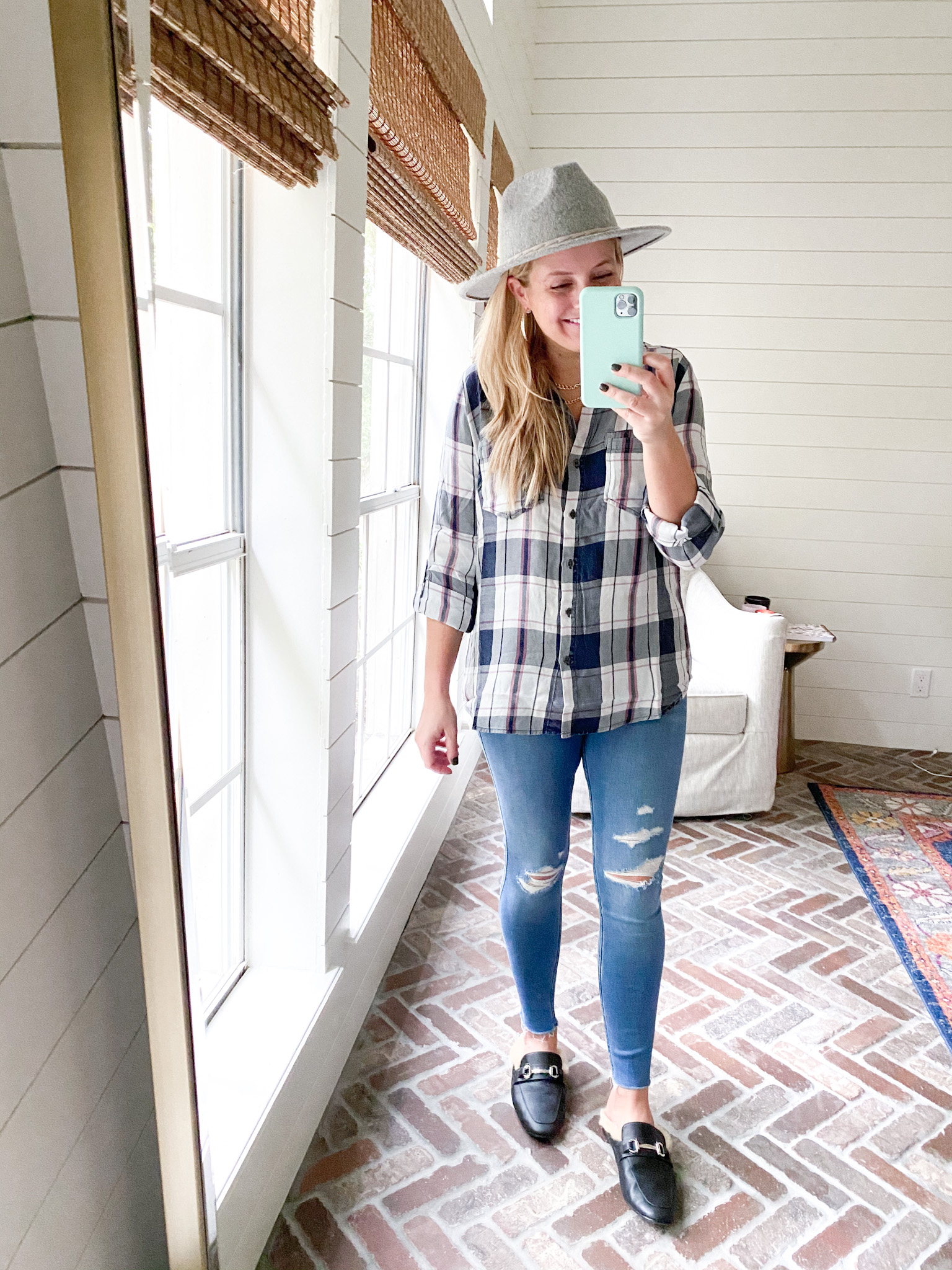 Cute Fall Outfits by popular Houston fashion blog, Fancy Ashley: image of a woman wearing a plaid top, grey felt hat, distressed jeans, and faux fur lined slide mules. 