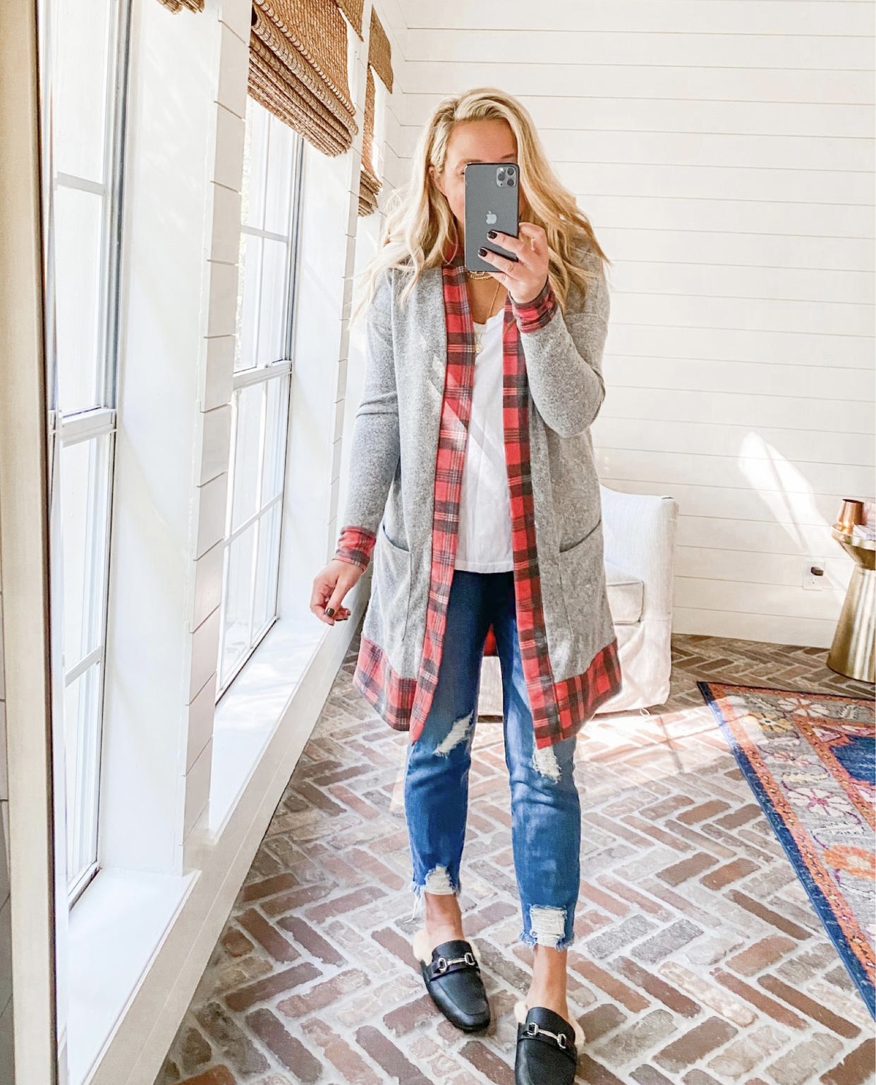 Cute Fall Outfits by popular Houston fashion blog, Fancy Ashley: image of a woman wearing a red plaid and grey cardigan, distressed jeans, and faux fur lined slide mules. 