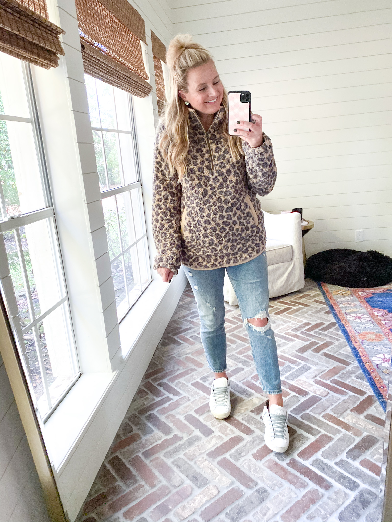 Cute Fall Outfits by popular Houston fashion blog, Fancy Ashley: image of a woman wearing a leopard print wubby fleece pullover, distressed jeans, and white sneakers. 