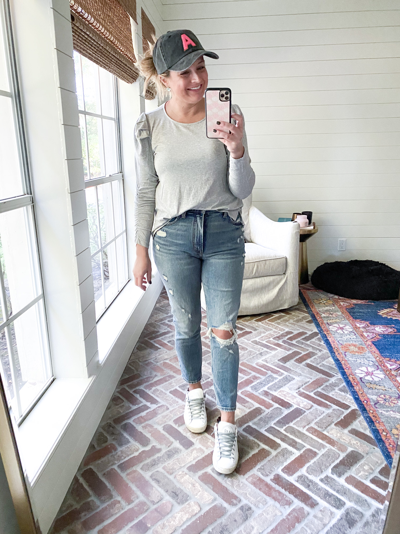 Gibson Look by popular Houston fashion blog, Fancy Ashley: image of a woman wearing a Gibson Look Cinched Sleeve Puff Shoulder Top, P448 sneakers, baseball hat, and Abercrombie and Fitch distressed jeans. 