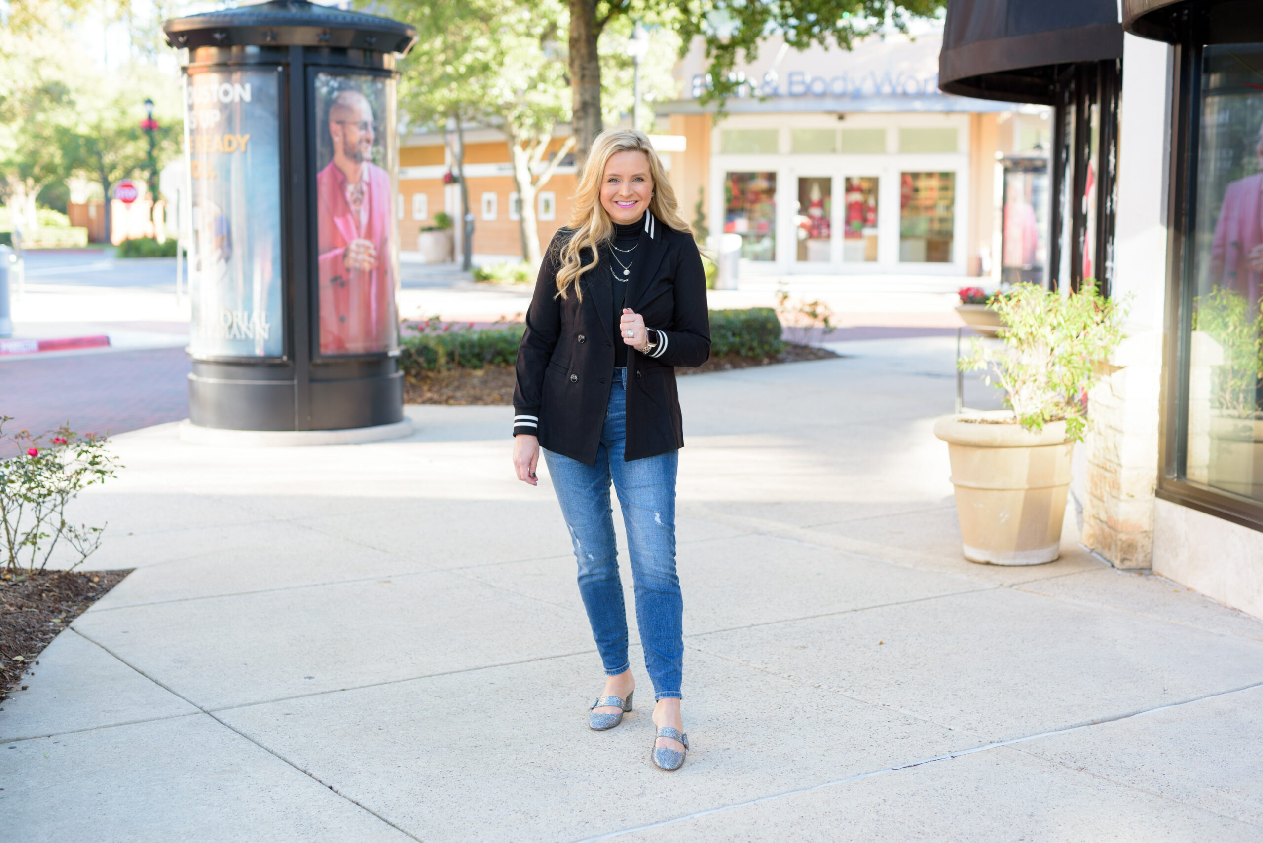 Winter Outfits by popular Houston fashion blog, Fancy Ashley: image of a woman standing outside and wearing Liverpool Los Angeles jeans, black turtleneck top, and a black blazer. 