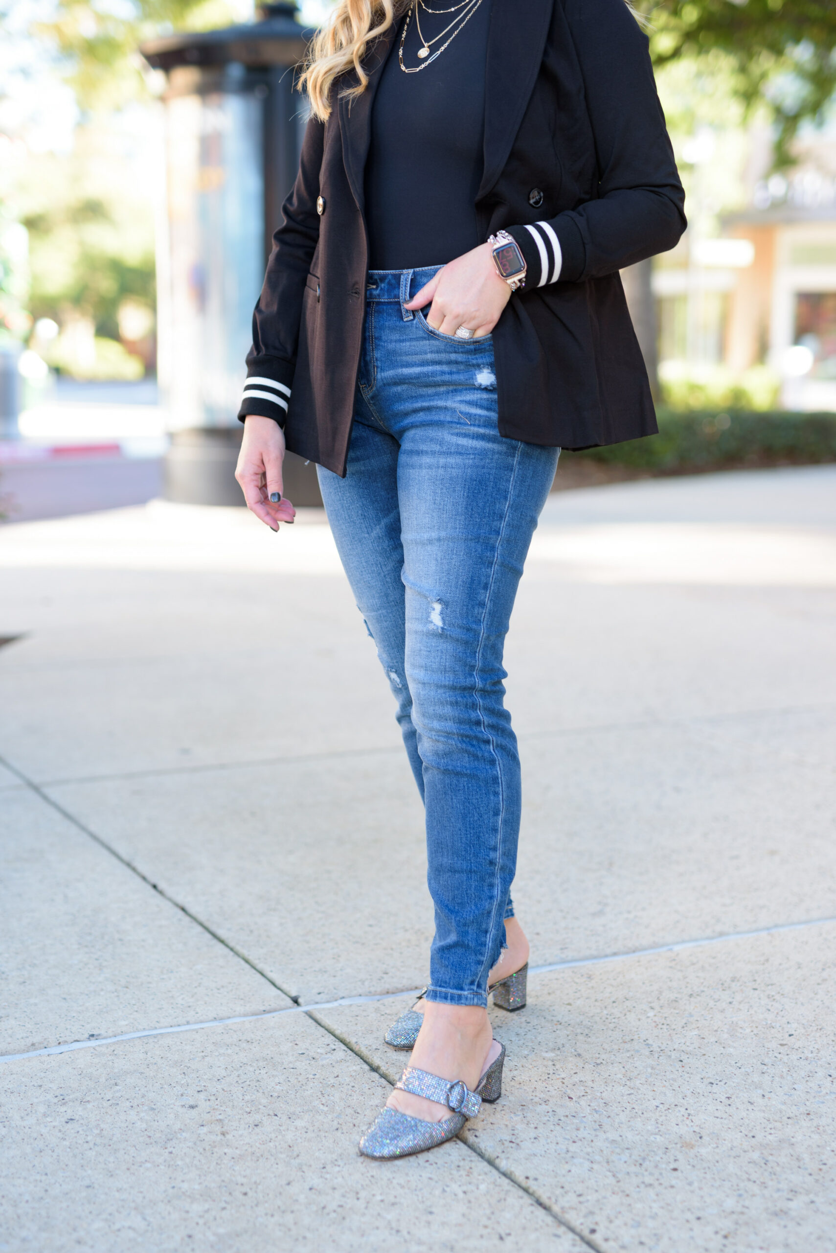 Winter Outfits by popular Houston fashion blog, Fancy Ashley: image of a woman standing outside and wearing Liverpool Los Angeles jeans, black turtleneck top, and a black blazer. 