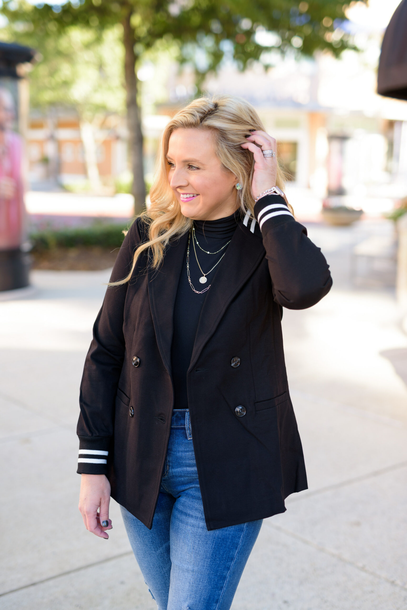 Winter Outfits by popular Houston fashion blog, Fancy Ashley: image of a woman standing outside and wearing Liverpool Los Angeles jeans, black turtleneck top, and a black blazer. 