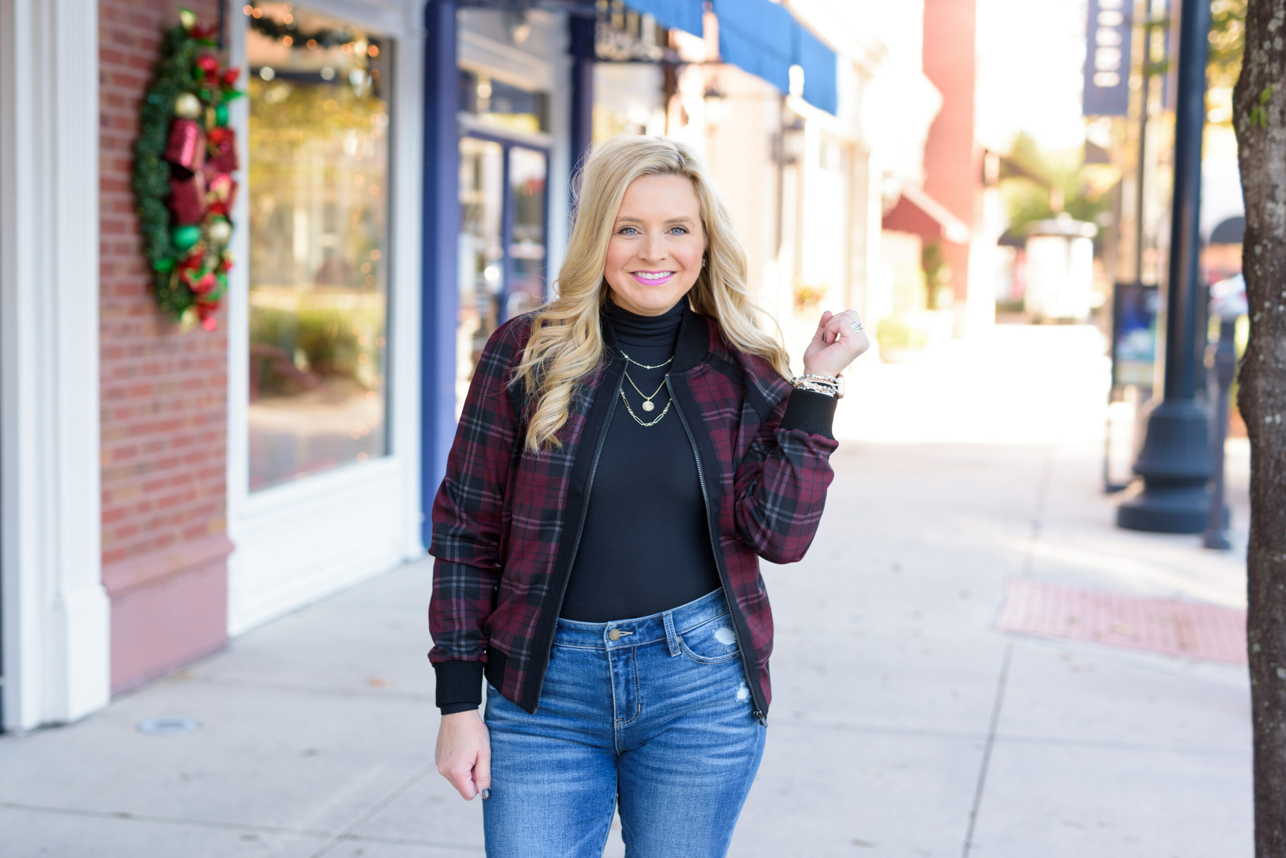 Winter Outfits by popular Houston fashion blog, Fancy Ashley: image of a woman standing outside and wearing Liverpool Los Angeles jeans, black turtleneck top, black ankle boots, and plaid jacket.