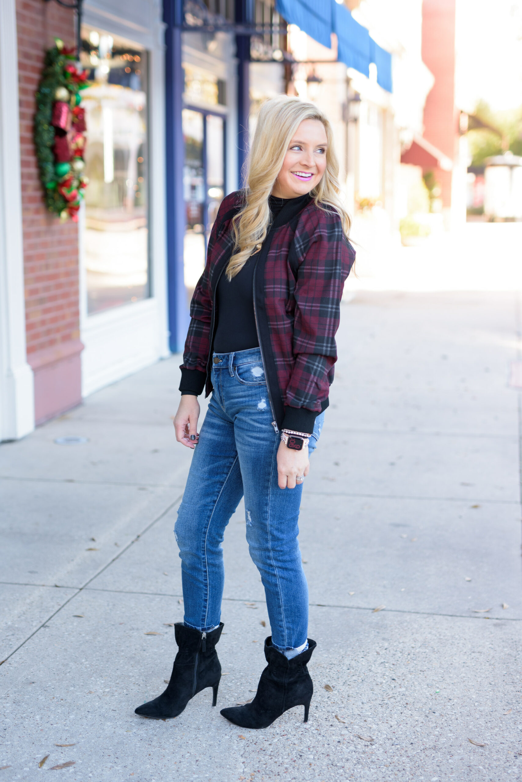 Winter Outfits by popular Houston fashion blog, Fancy Ashley: image of a woman standing outside and wearing Liverpool Los Angeles jeans, black turtleneck top, black ankle boots, and plaid jacket.