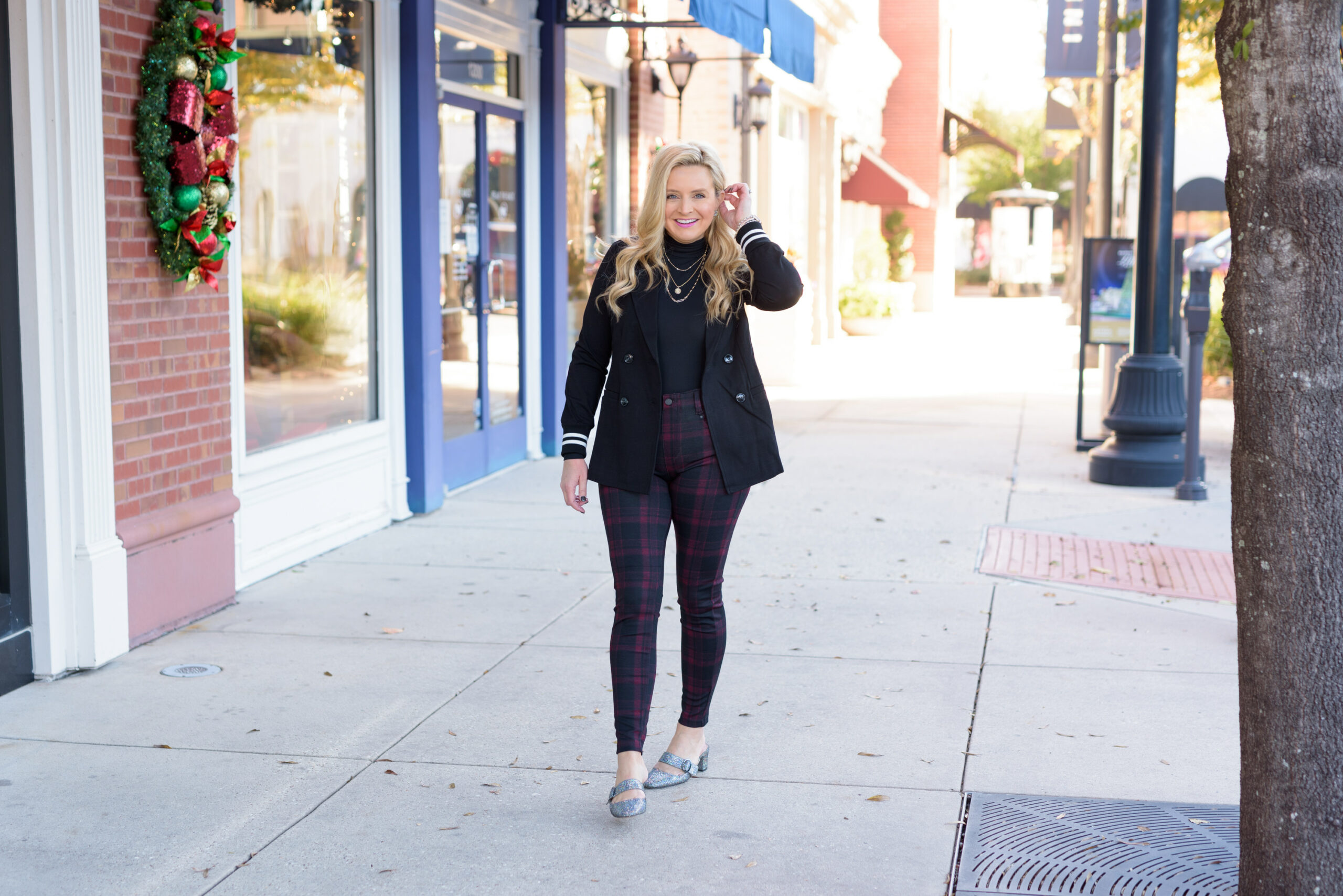 Winter Outfits by popular Houston fashion blog, Fancy Ashley: image of a woman standing outside and wearing Liverpool Los Angeles plaid pants, black turtleneck top, and black blazer. 