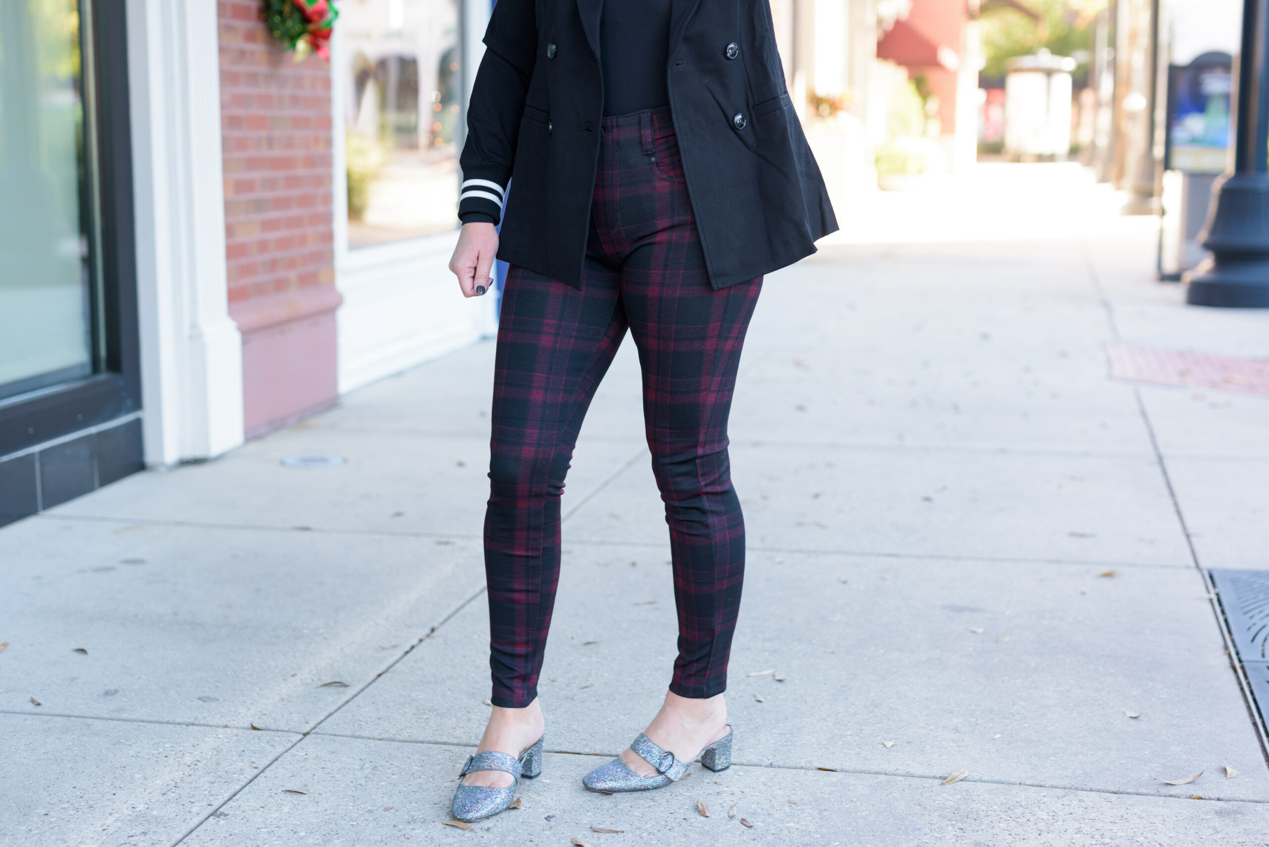 Winter Outfits by popular Houston fashion blog, Fancy Ashley: image of a woman standing outside and wearing Liverpool Los Angeles plaid pants, black turtleneck top, and black blazer. 