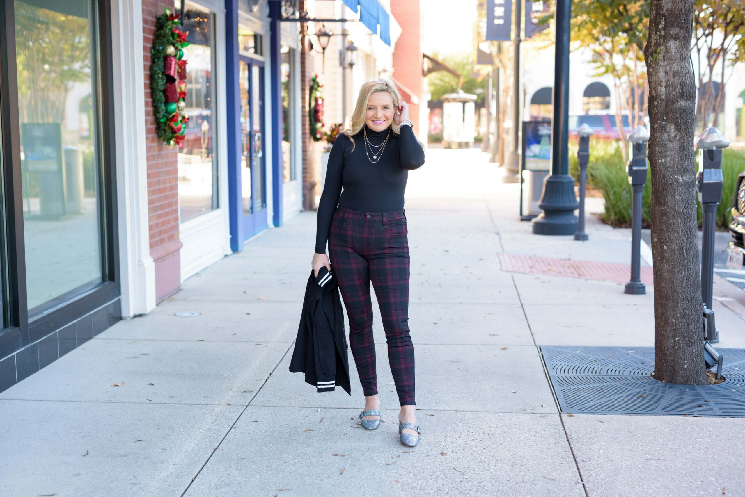 Winter Outfits by popular Houston fashion blog, Fancy Ashley: image of a woman standing outside and wearing Liverpool Los Angeles plaid pants, black turtleneck top, and black blazer. 