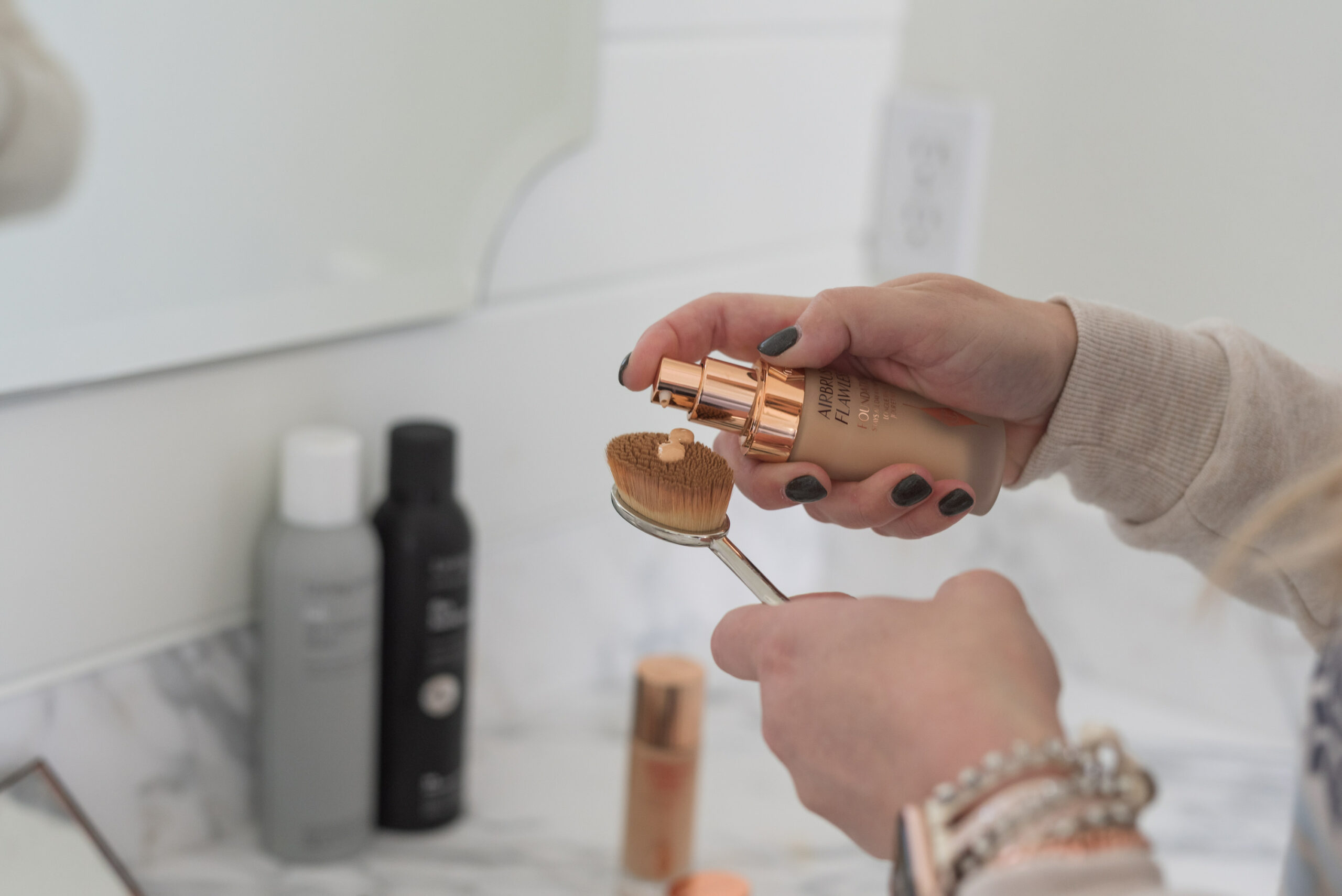 Nordstrom Beauty by popular Houston beauty blog, Fancy Ashley: image of a woman applying Clinique foundation to a makeup brush. 
