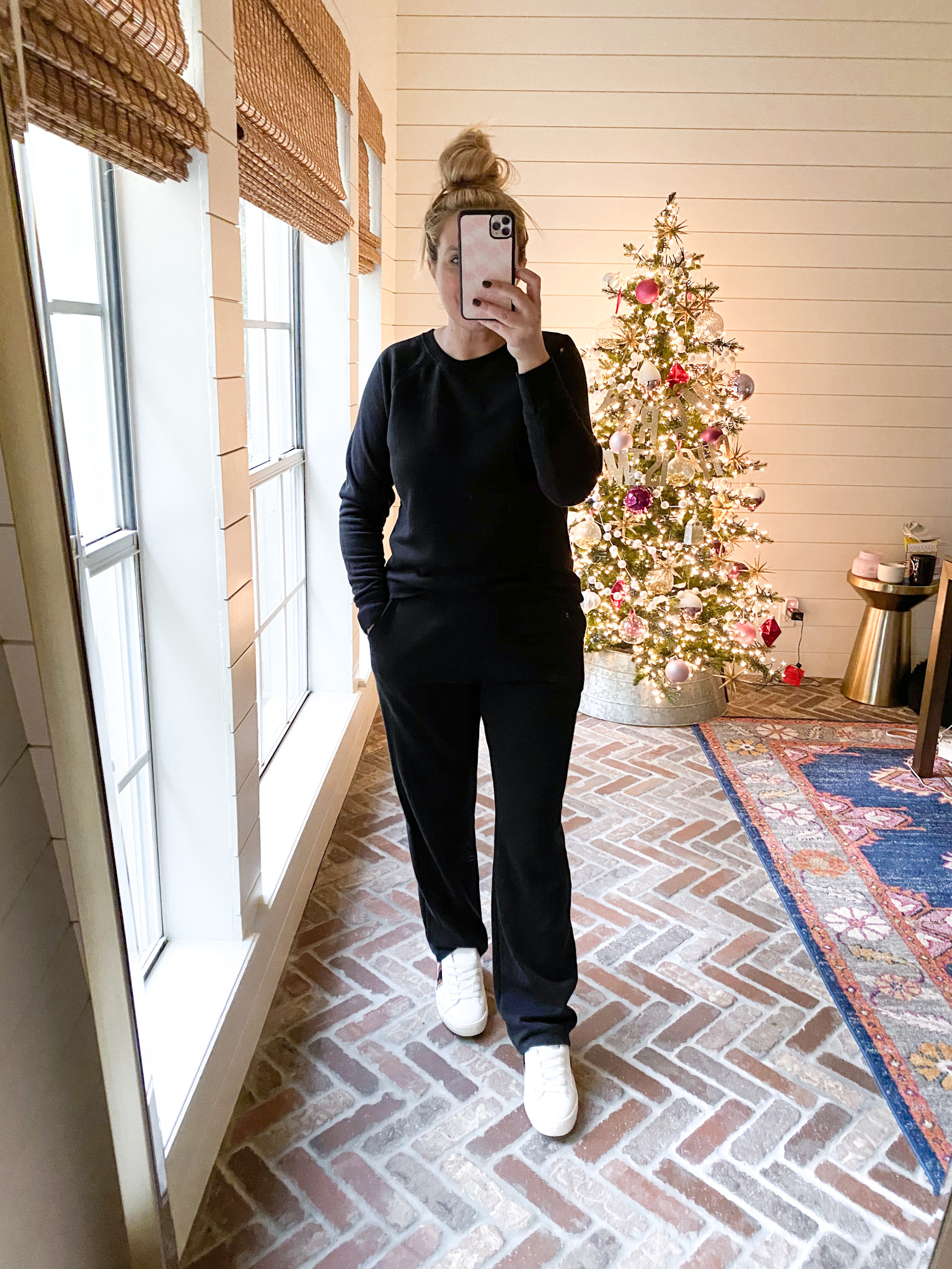 Walmart Fashion by popular Houston fashion blog, Fancy Ashley: image of a woman wearing a black long sleeve shirt, black lounge pants, and white sneakers. 