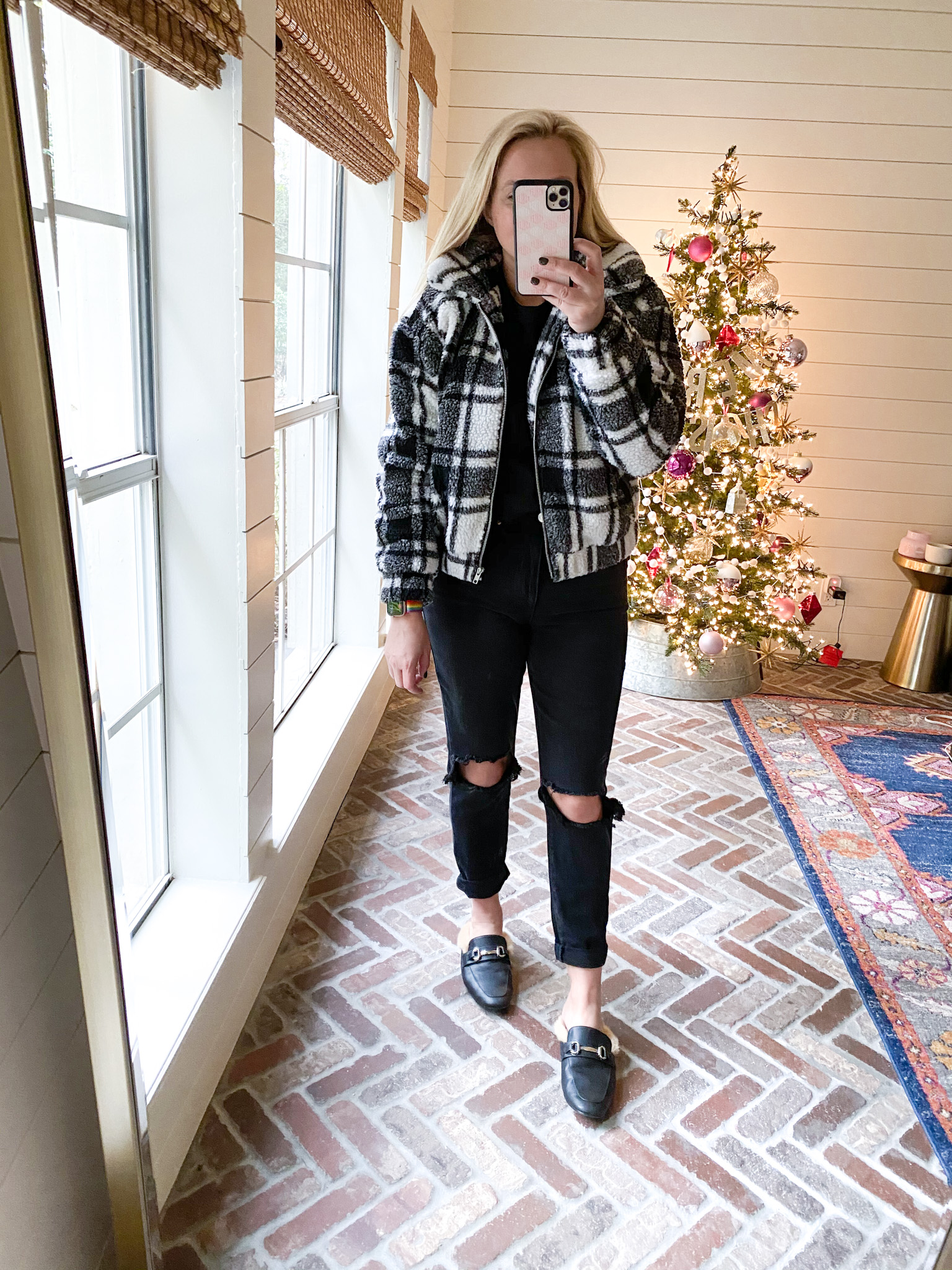 Walmart Fashion by popular Houston fashion blog, Fancy Ashley: image of a woman wearing a black and white plaid sherpa jacket, fur line black slides, black distressed denim and black shirt.