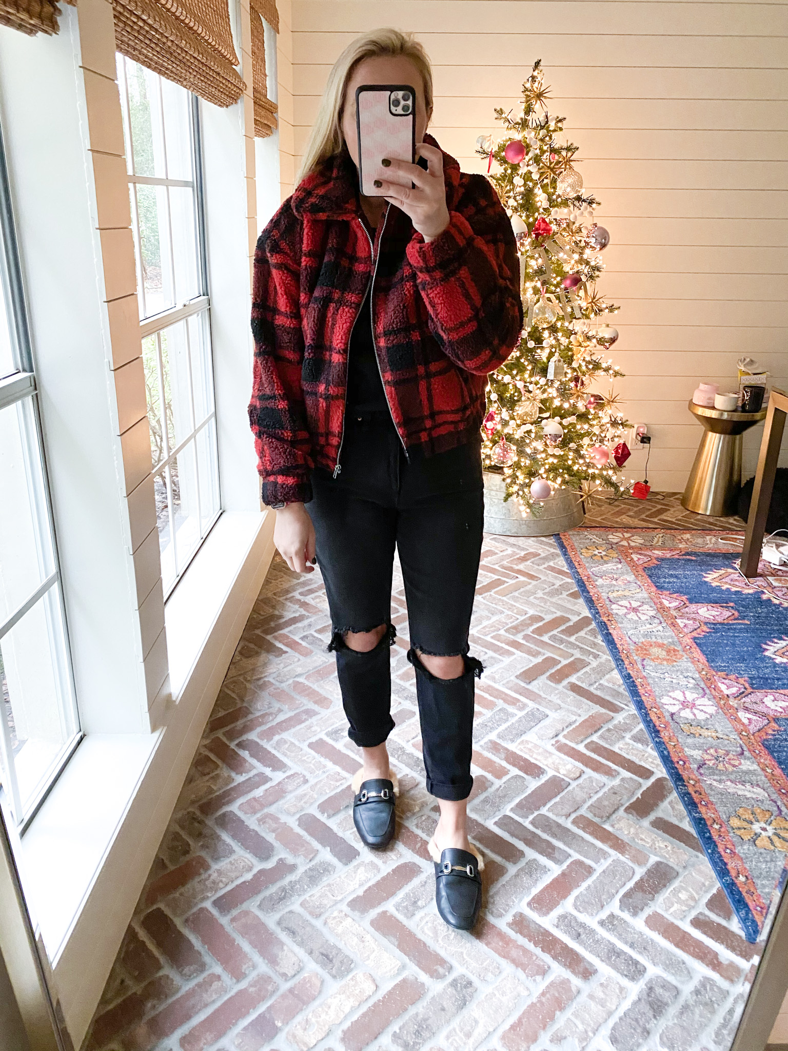 Walmart Fashion by popular Houston fashion blog, Fancy Ashley: image of a woman wearing a black and red plaid sherpa jacket, fur line black slides, black distressed denim and black shirt.