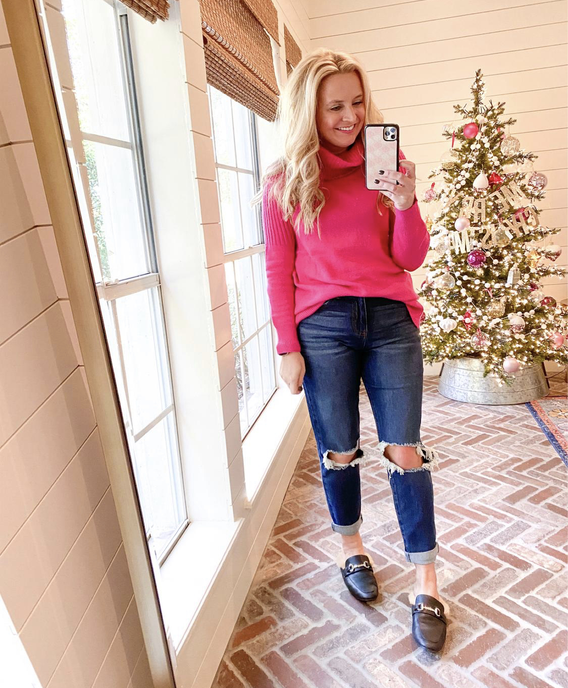 November Outfits by popular Houston fashion blog, Fancy Ashley: image of a woman wearing a pink sweater, distressed denim, and black fur lined slide on loafers. 