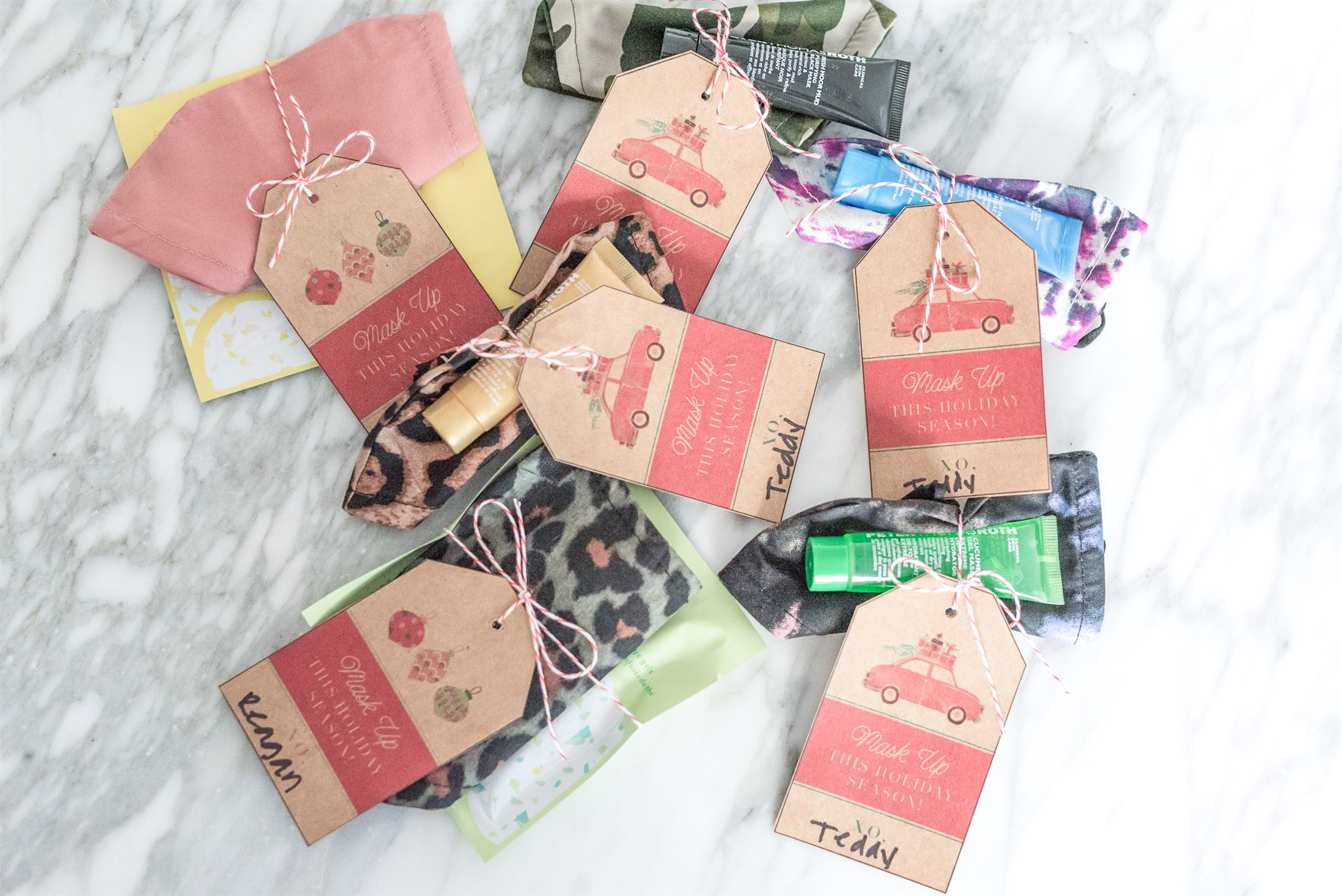Christmas Gift for Teachers by popular Houston life and style blog, Fancy Ashley: image of face masks wrapped with gift tags and bakers twine. 