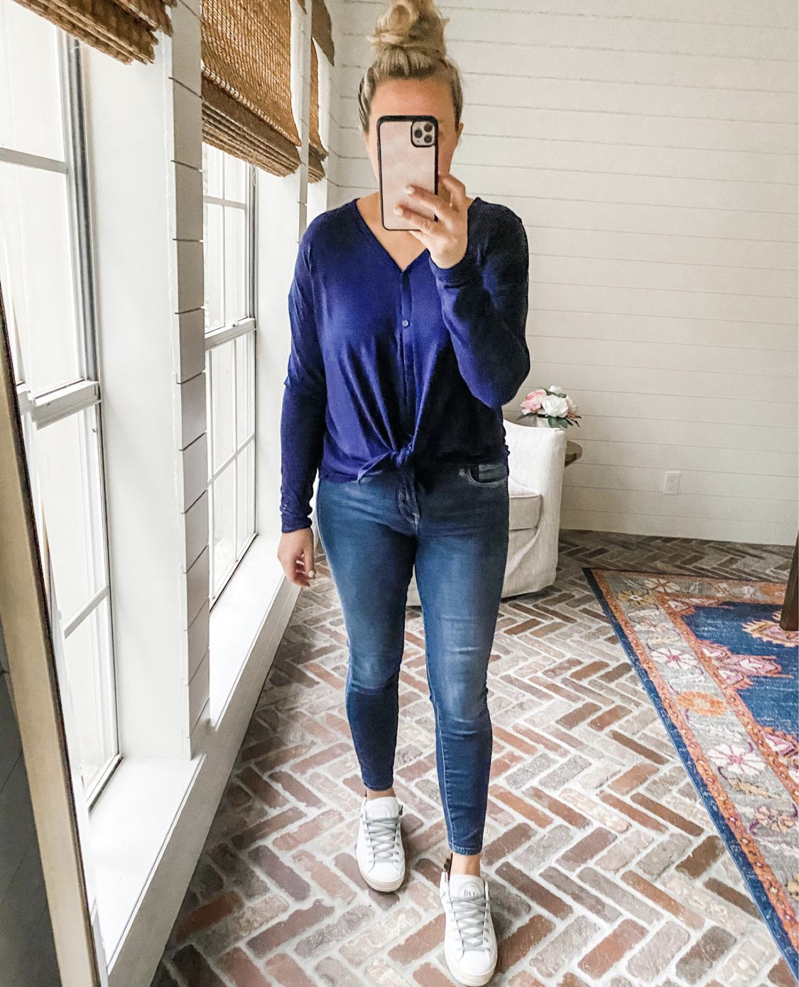 Like To Know It by popular Houston life and style blog, Fancy Ashely: image of a woman wearing a blue long sleeve tie front shirt, jeans, and white sneakers. 