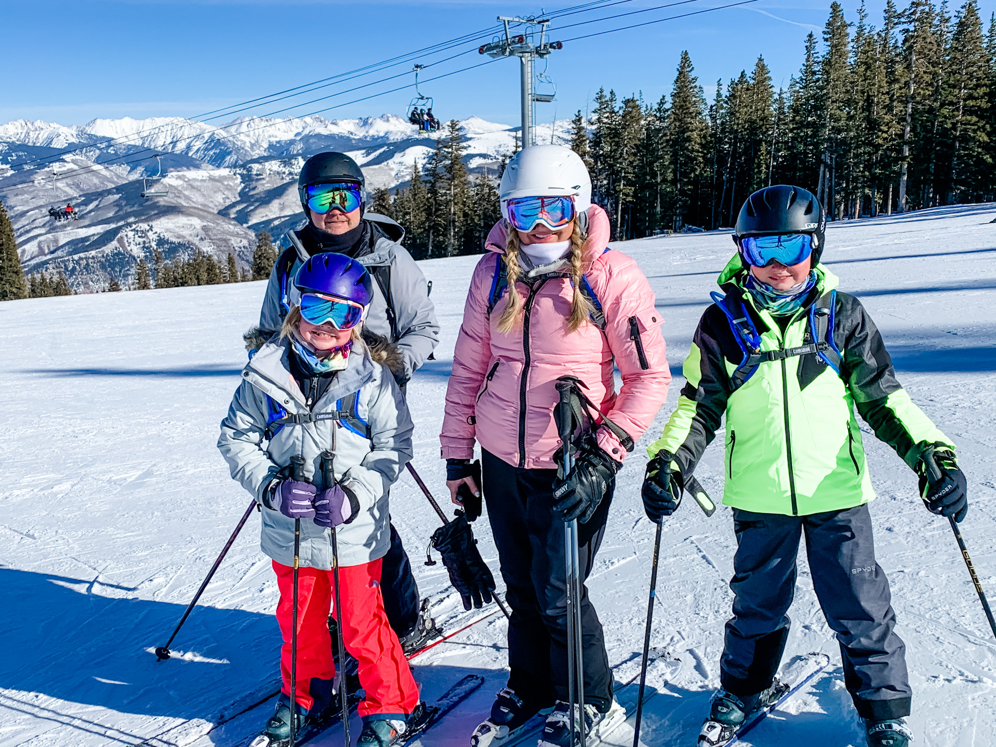 What to Pack for a Ski Trip by popular Houston lifestyle blog, Fancy Ashley: image of a family wearing ski gear on a ski slope. 