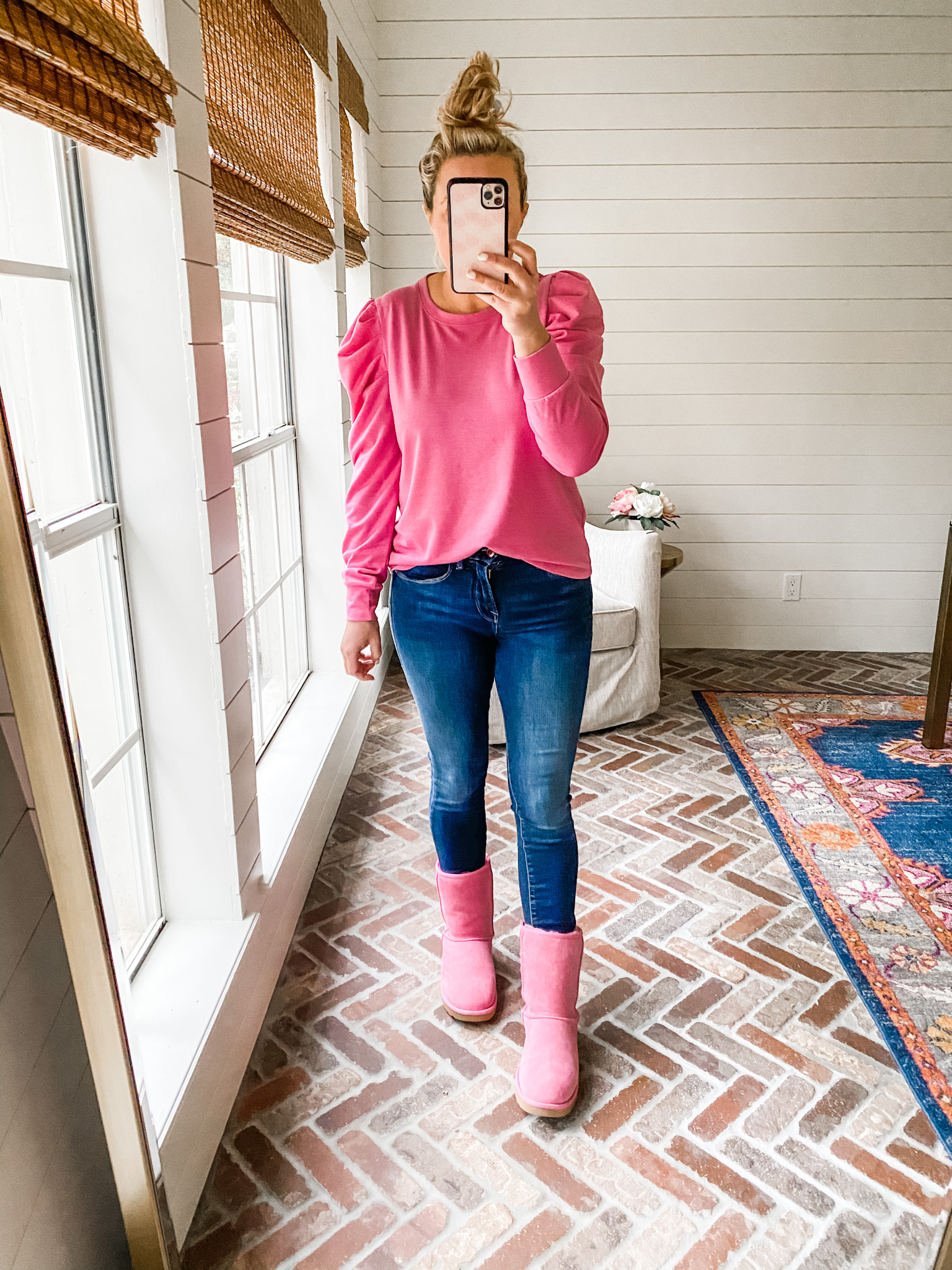 Like To Know It by popular Houston life and style blog, Fancy Ashely: image of a woman wearing a pink puff sleeve shirt, jeans, and pink UGG boots. 
